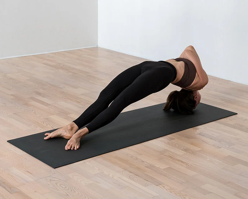 Private Yoga teacher Katharina Fengler demonstrating Asthanga Yoga Primary Series pose Setu Bandhasana in Berlin Mitte studio space. 