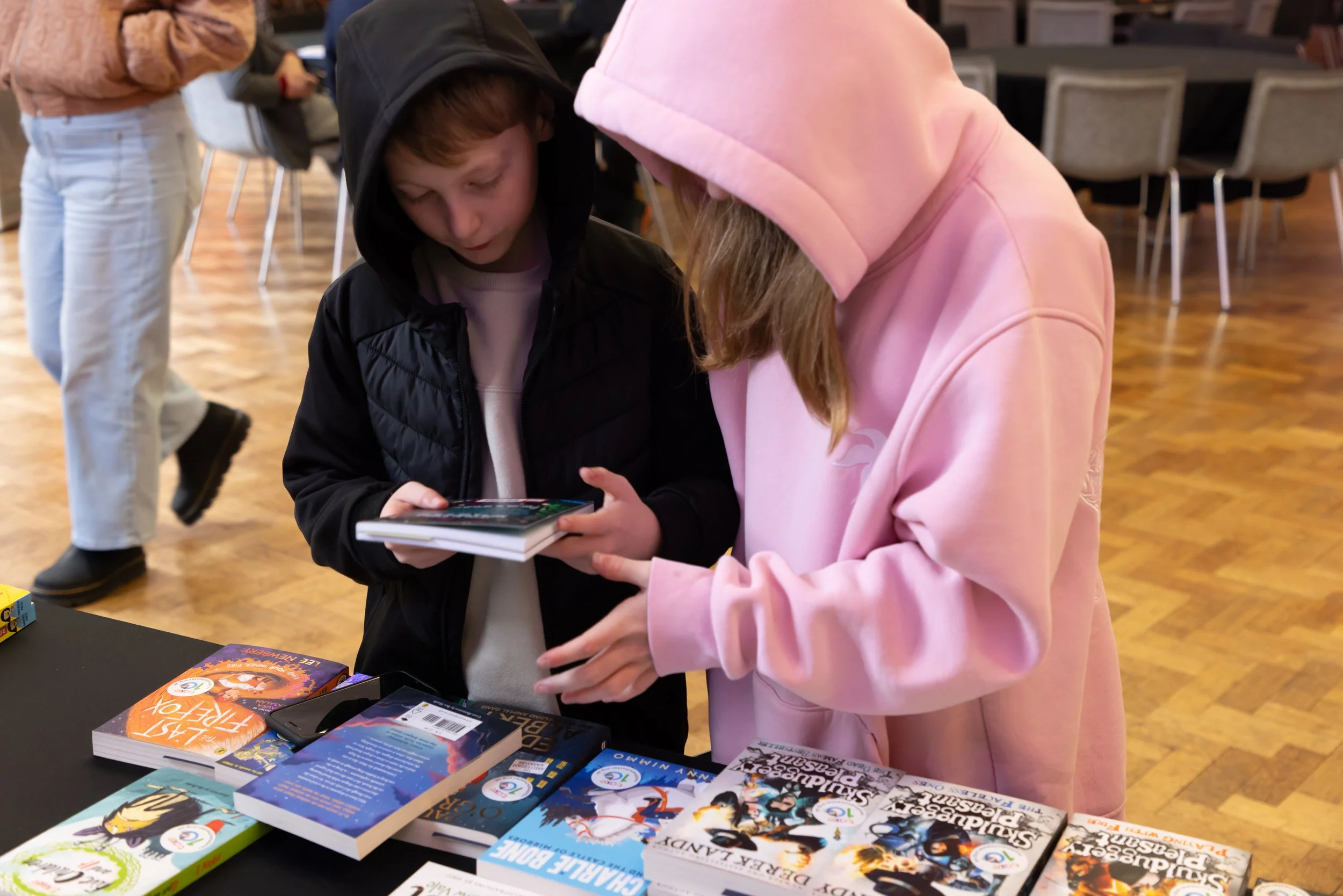 Millie and her brother looking at a book.jpg
