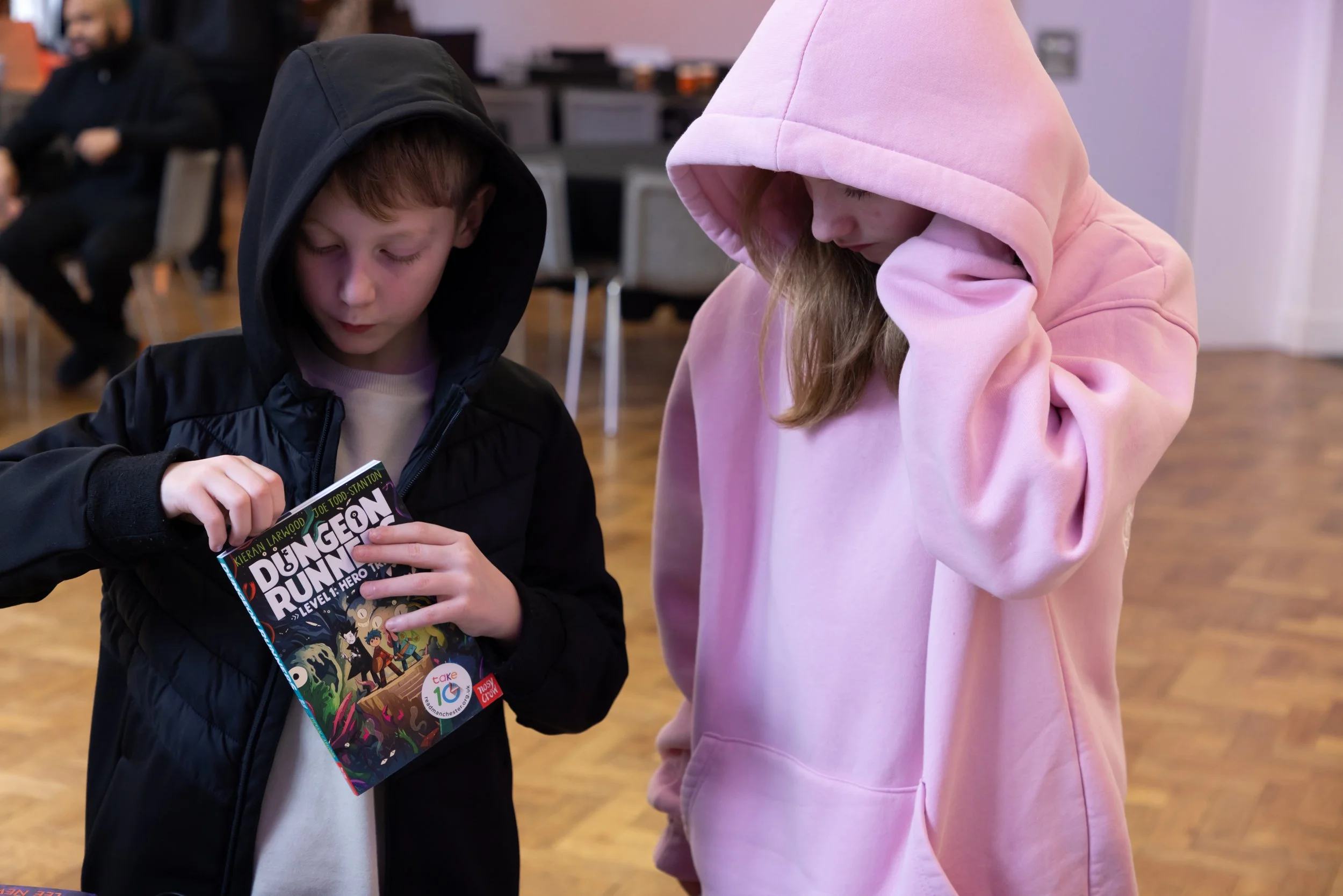 Millie and her brother with a book.jpg