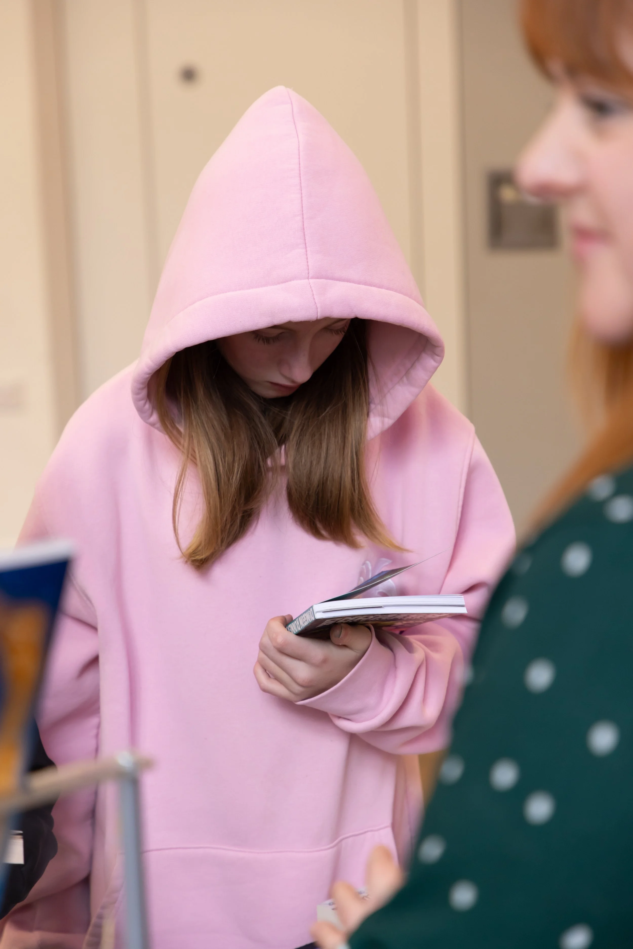 Millie, Inscape House, face down, looking at a book.jpg