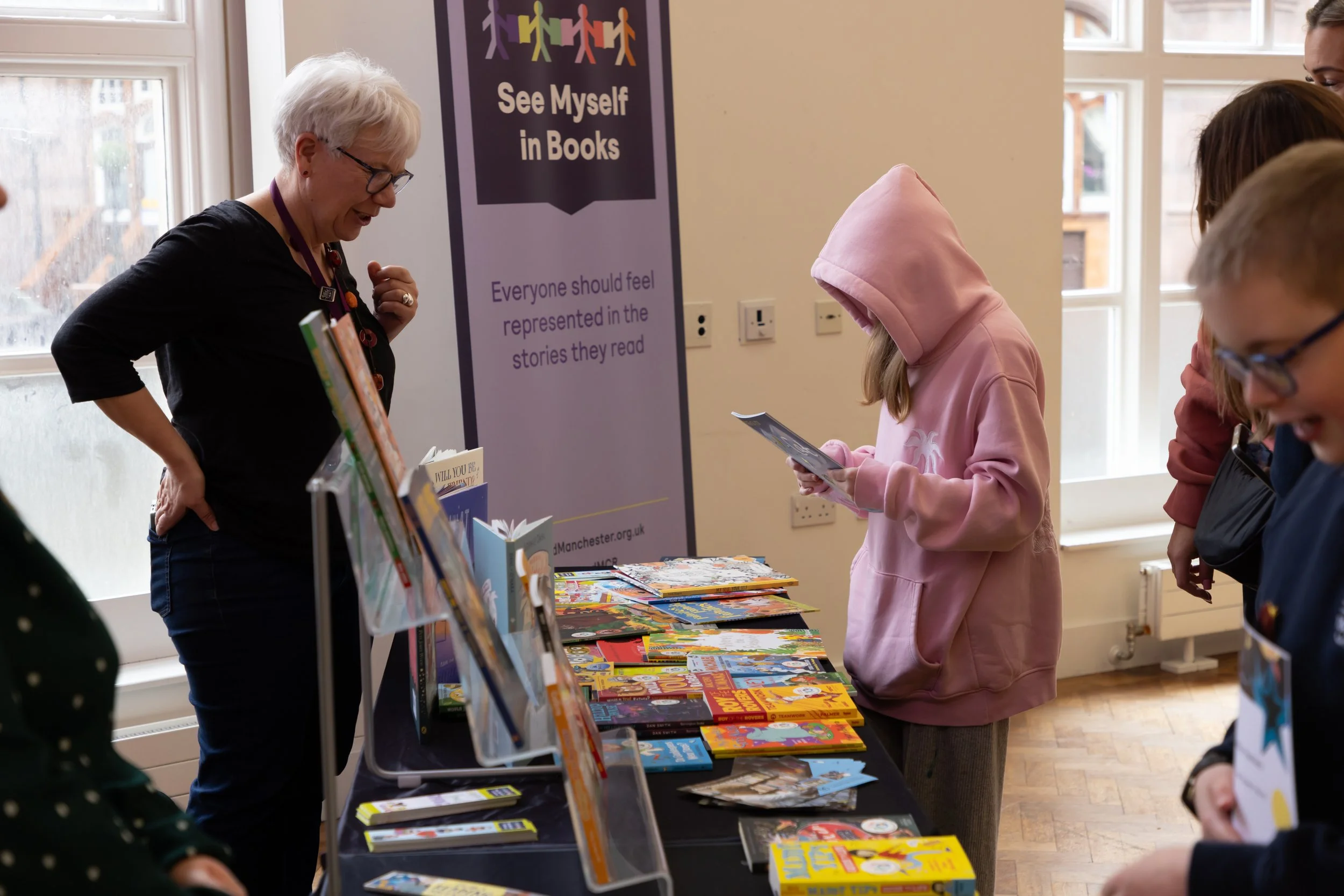 Millie, Inscape House, looking at book, with Cheryl.jpg