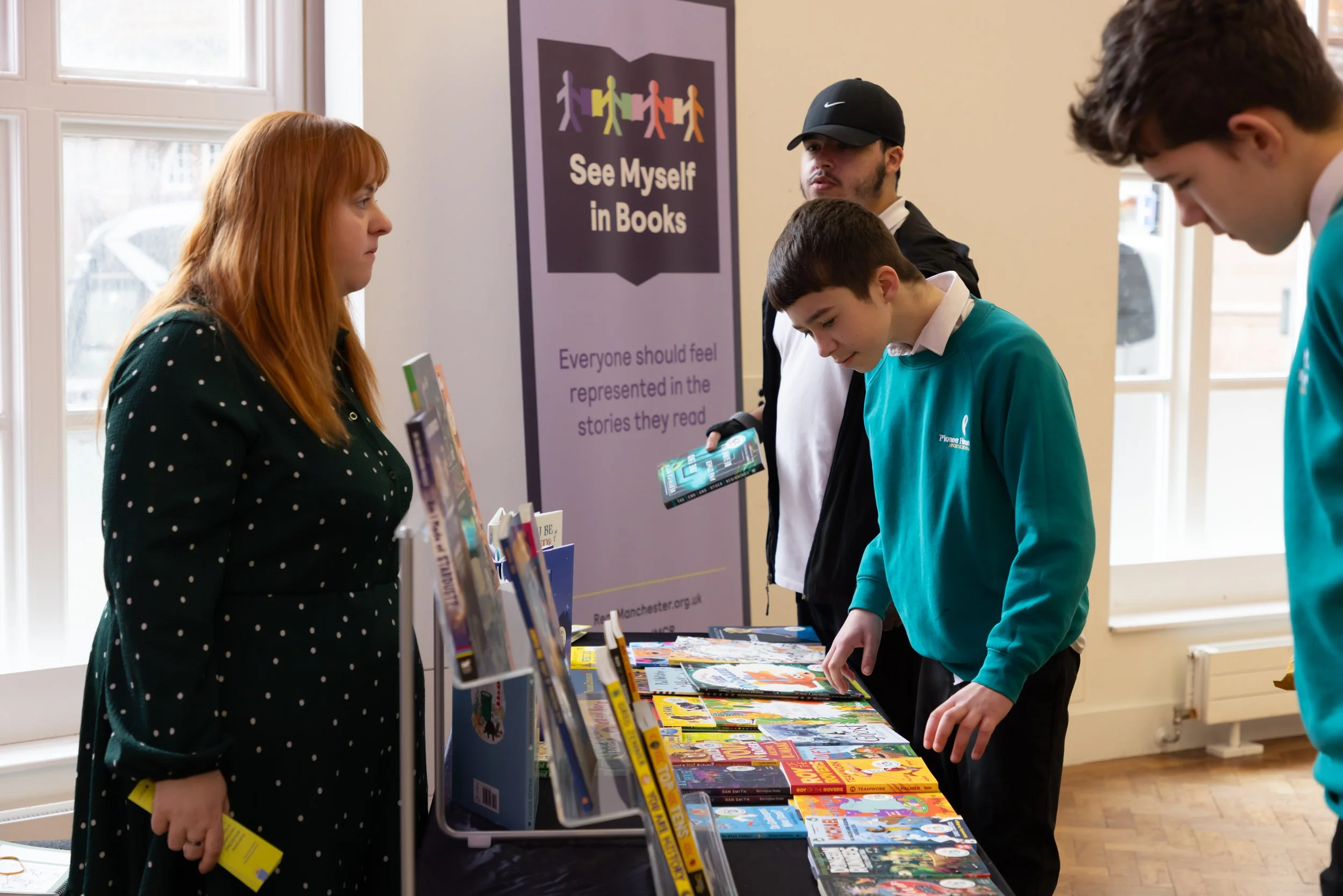 Pioneer House Students choosing books with Caroline.jpg