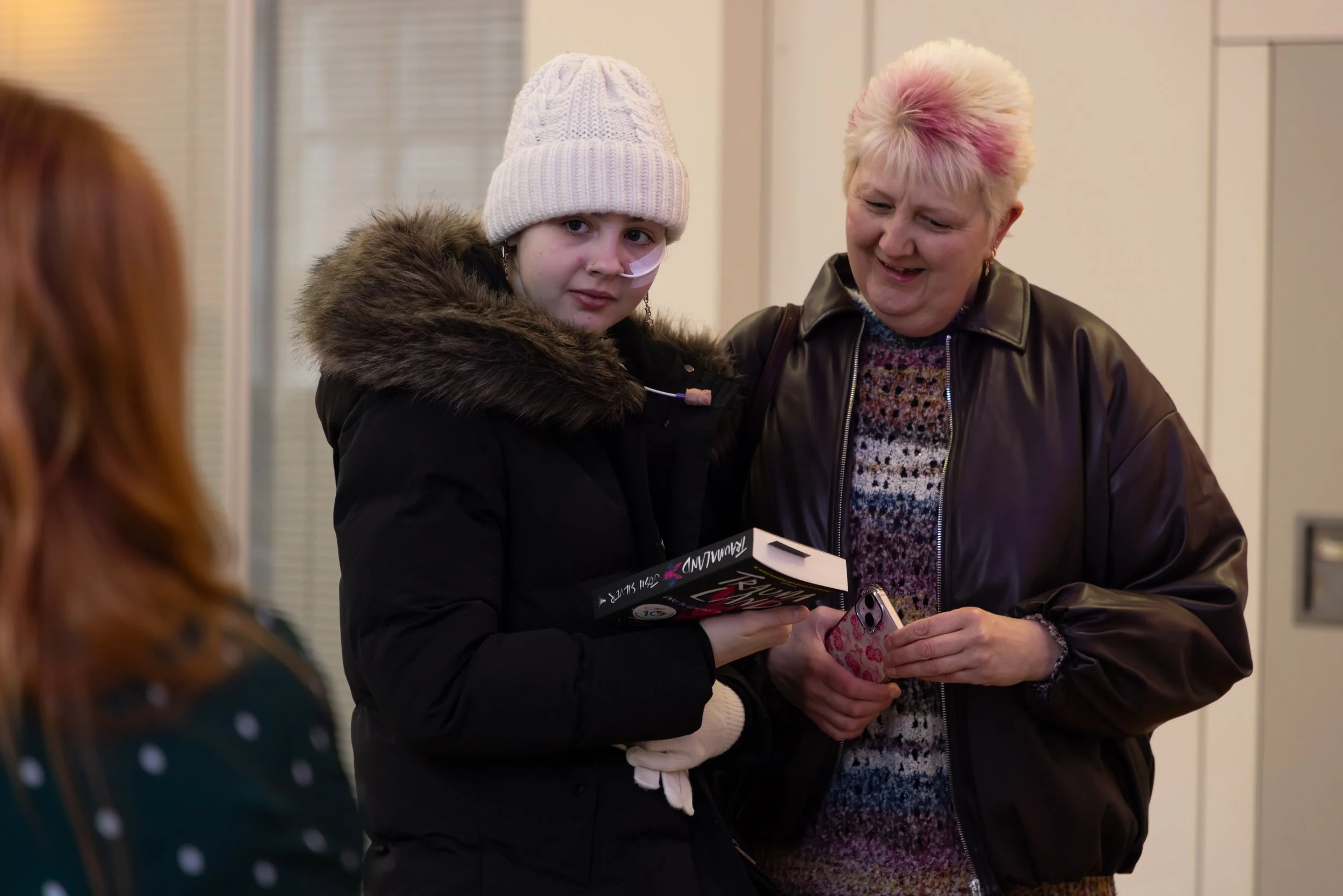 Teagan, MHS and mum with book looking at Caroline.jpg