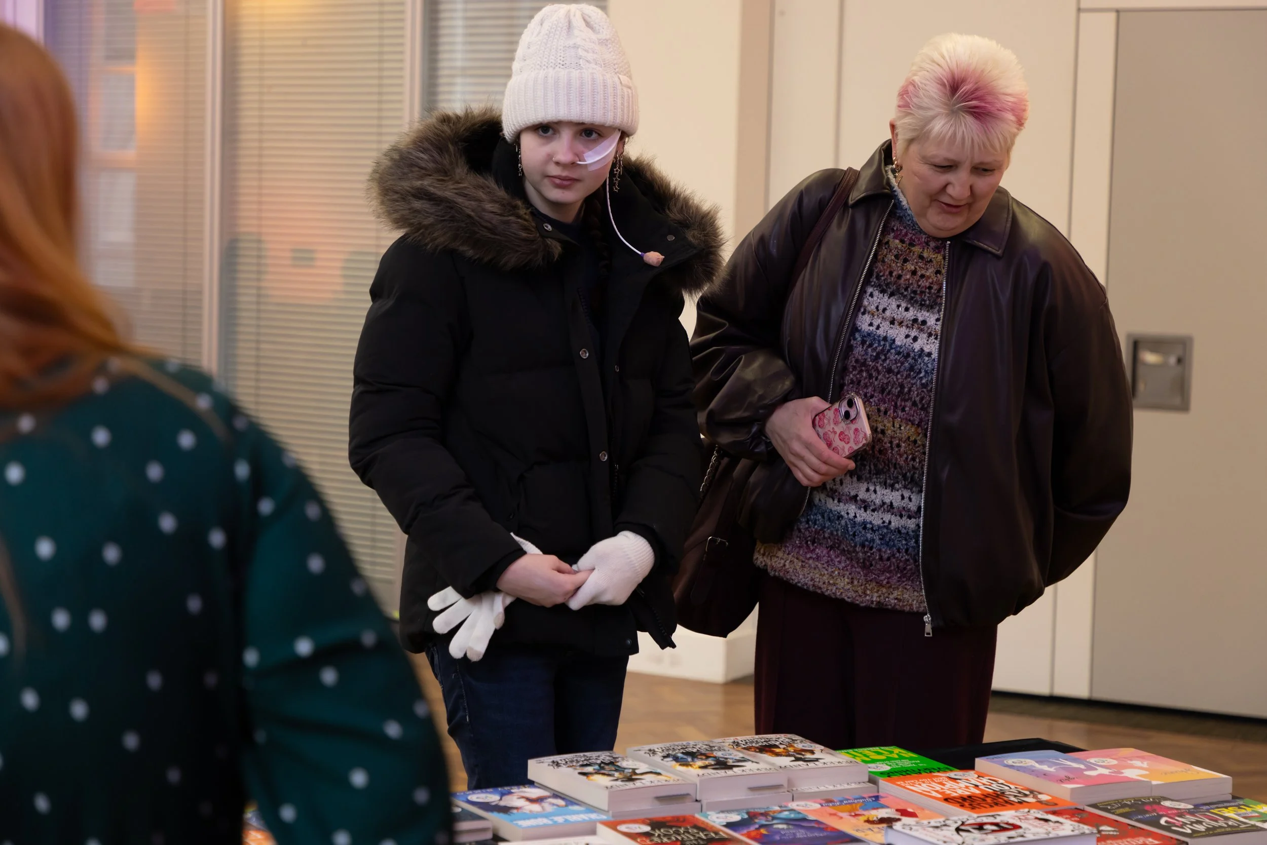 Teagan, MHS and mum looking at books.jpg