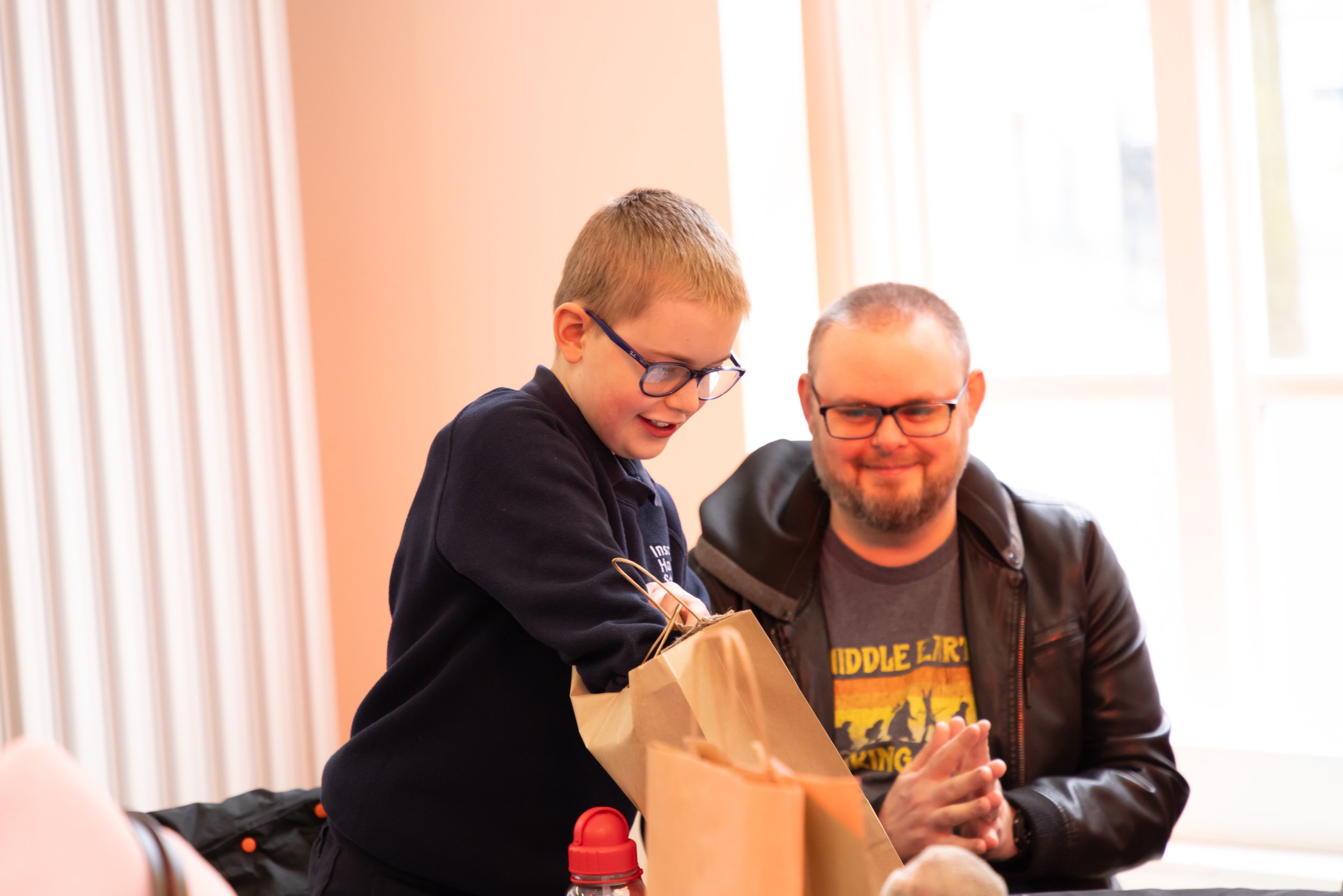Eddie, with parent, looking in bag.jpg