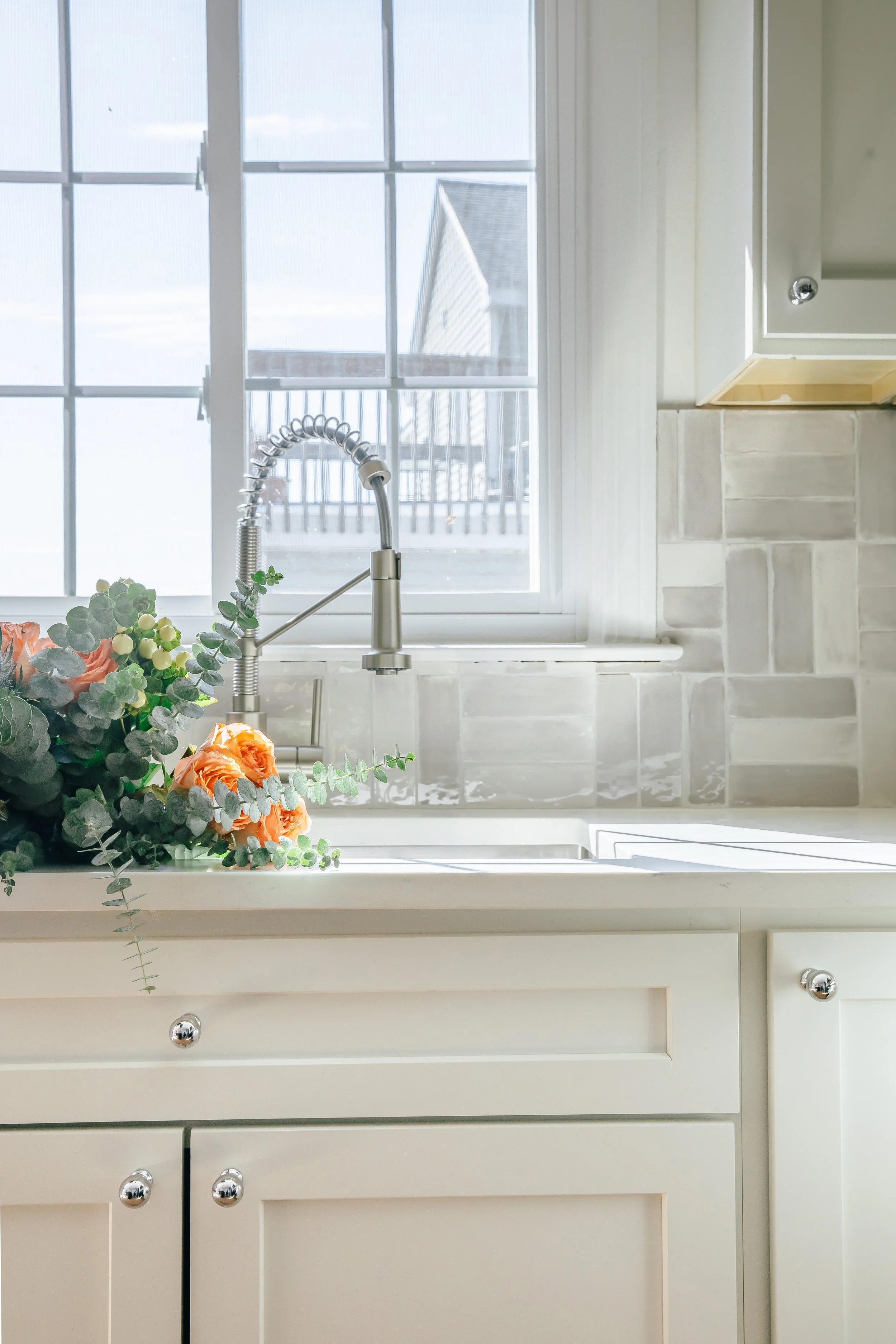 house-of-huck-milford-connecticut-flipped-renovation-waterfront-sink-flowers.jpg