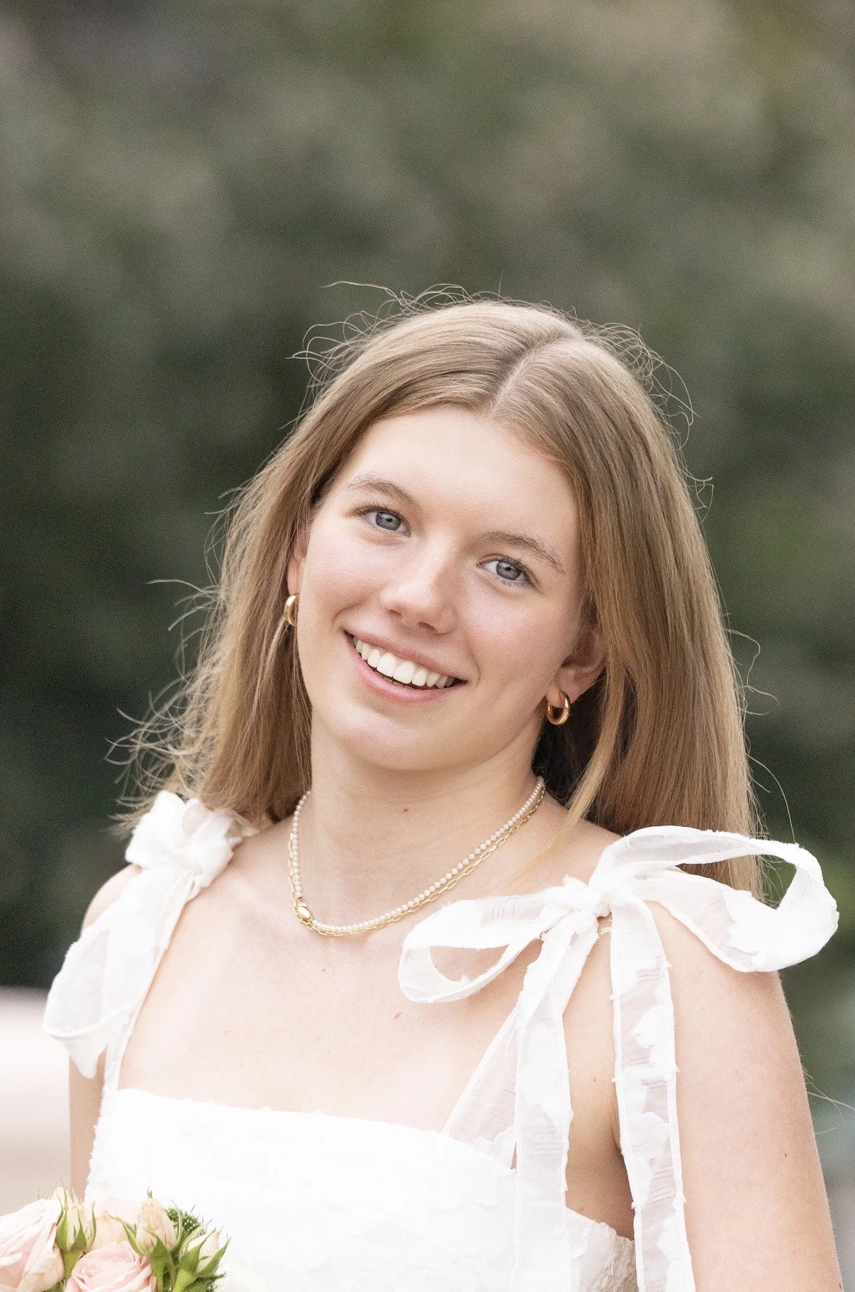 A woman with long blonde hair smiles into the camera
