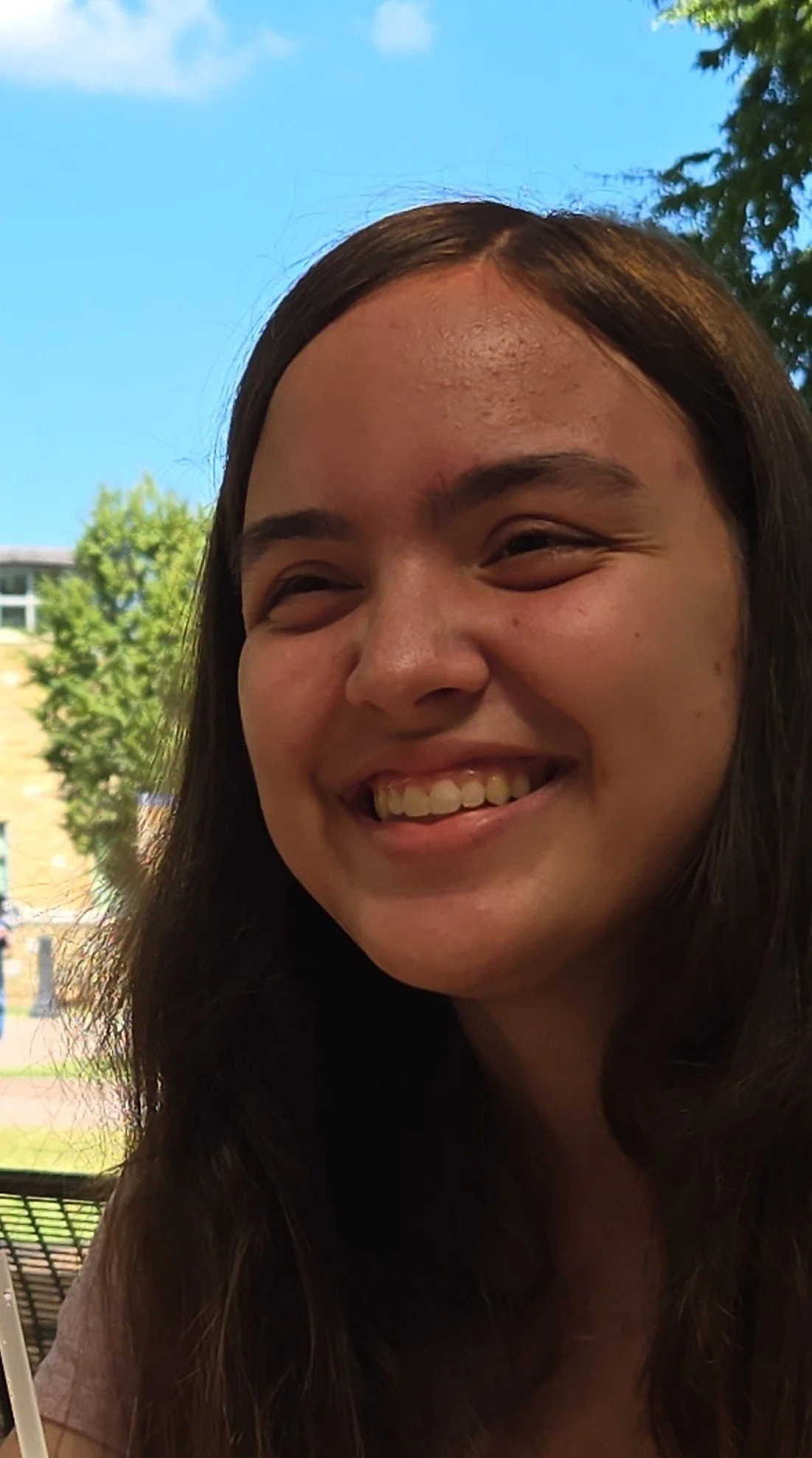 A woman smiles into the camera