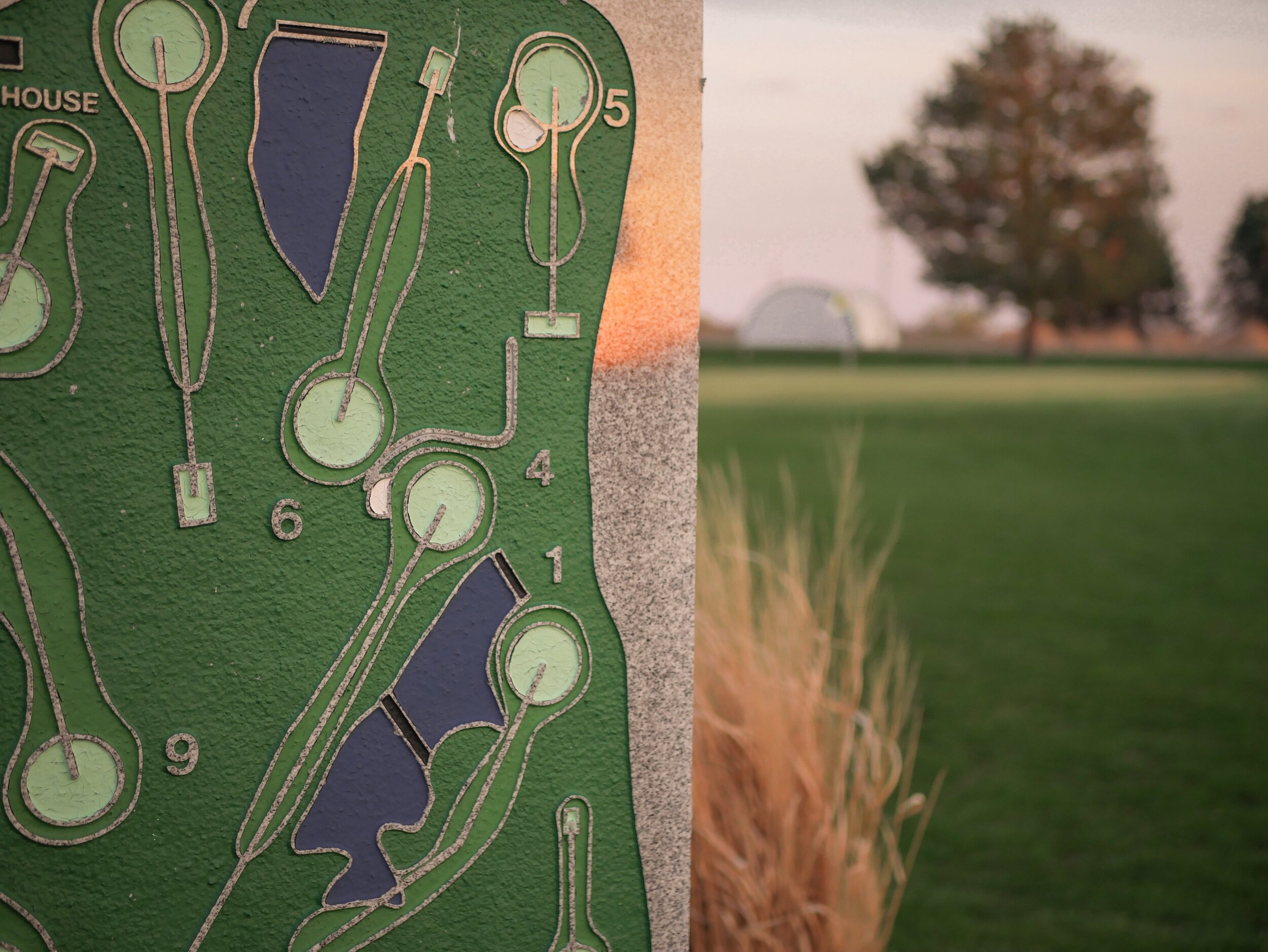 golf course layout design on stone with golf green in background
