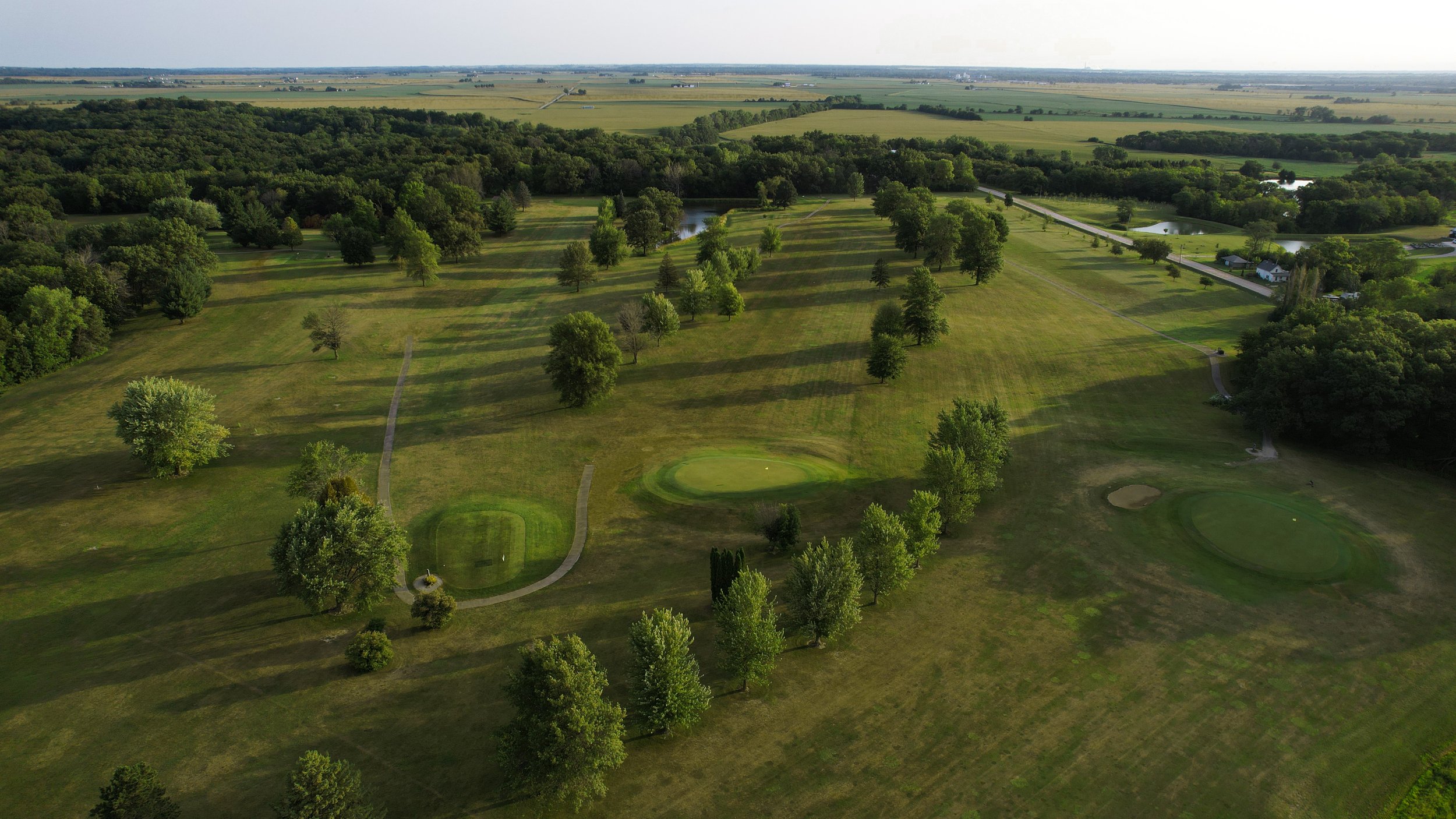 aerial view of golf course showing long fairways and bright greens