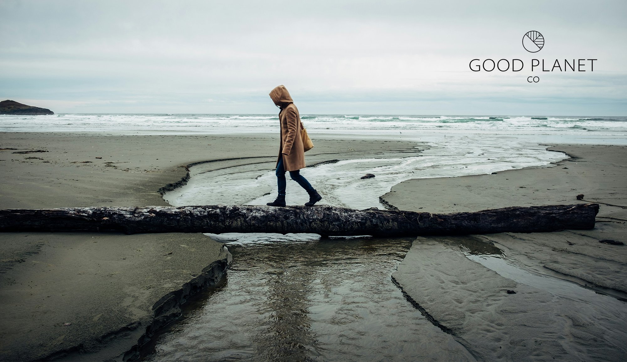 girl walking across log on beach in Tofino