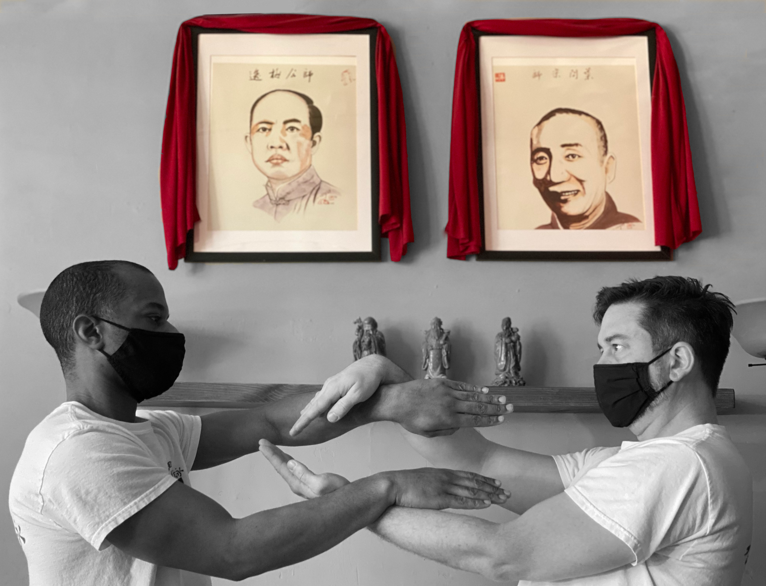 Daisihing Immaneul and his Sidai Mike practicing in front of the founders, Moy Yat and Yip Man