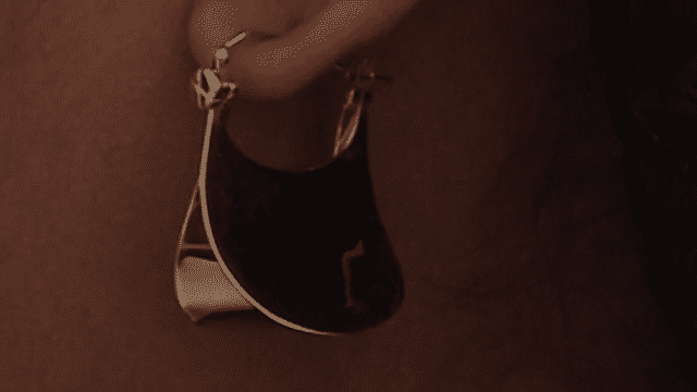 Dominique wears Tear Earrings 01, with an 18K Gold — Sterling Silver finish.