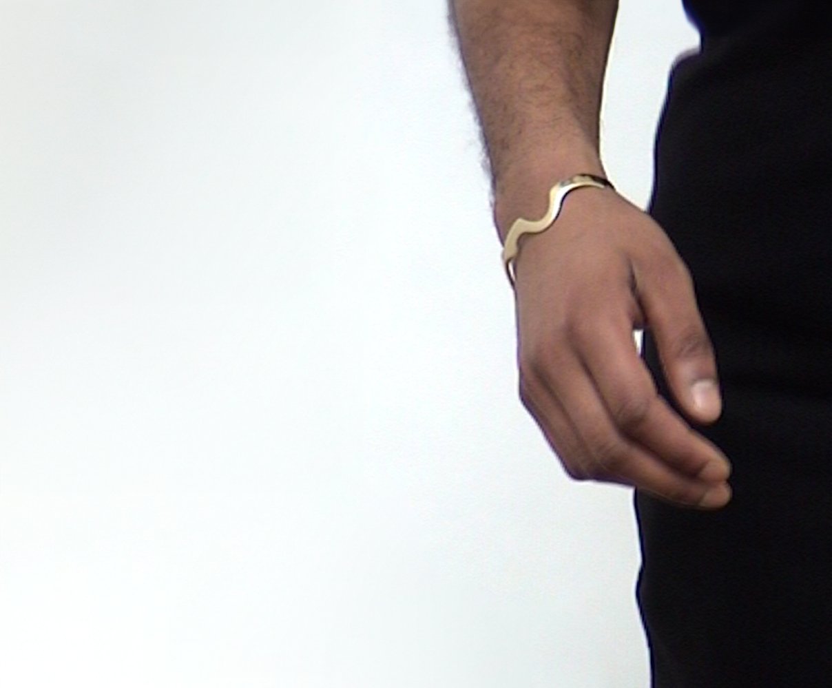 Remi wears Wave Bracelet 01, size M, with an 18K Gold — Sterling Silver finish.