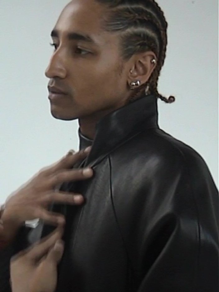 Robby wears three Element Earring 01 in Silver Rhodium finish.