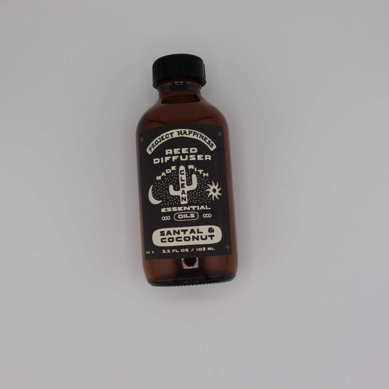 Santal & Coconut Reed Diffuser in an amber glass bottle with black reeds, featuring creamy coconut, sandalwood, tonka bean, and cedar for a warm, beach-inspired fragrance. Lasts 3–4 months.
