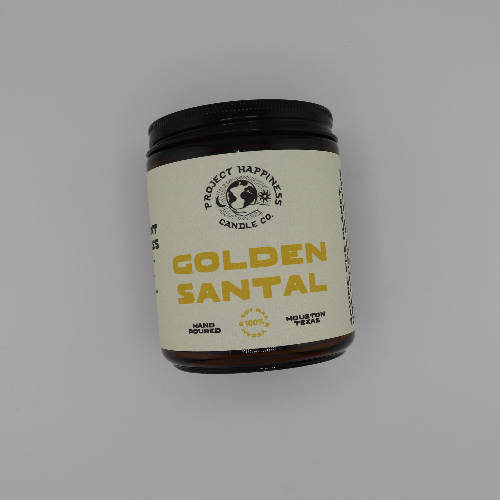 Santal Apothecary soy candle in an amber glass jar, featuring fresh herbal notes of fennel, sage, peppercorn, cedar, moss, balsam, musk, and sandalwood. Burns for 45–50 hours.