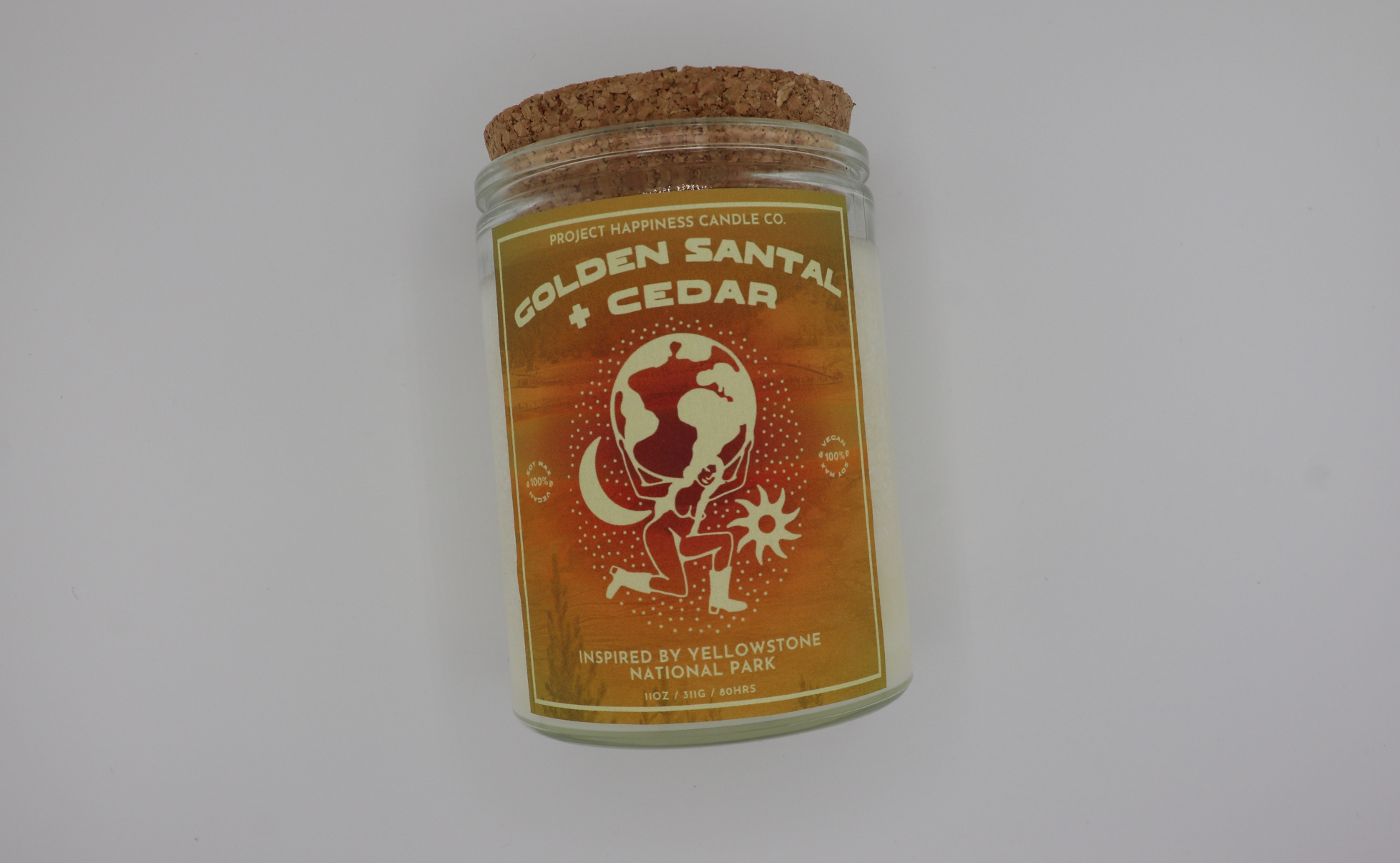 A Golden Santal and Cedar Soy Candle, displayed on a shelf, showcasing its natural ingredients and refined design.