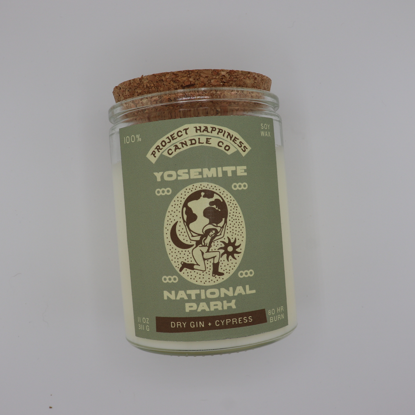 Yosemite soy candle in a glass jar, featuring fresh notes of juniper, gin, red currant, oak, cedar, cypress, and balsam inspired by the forest. Burns for 80–100 hours.