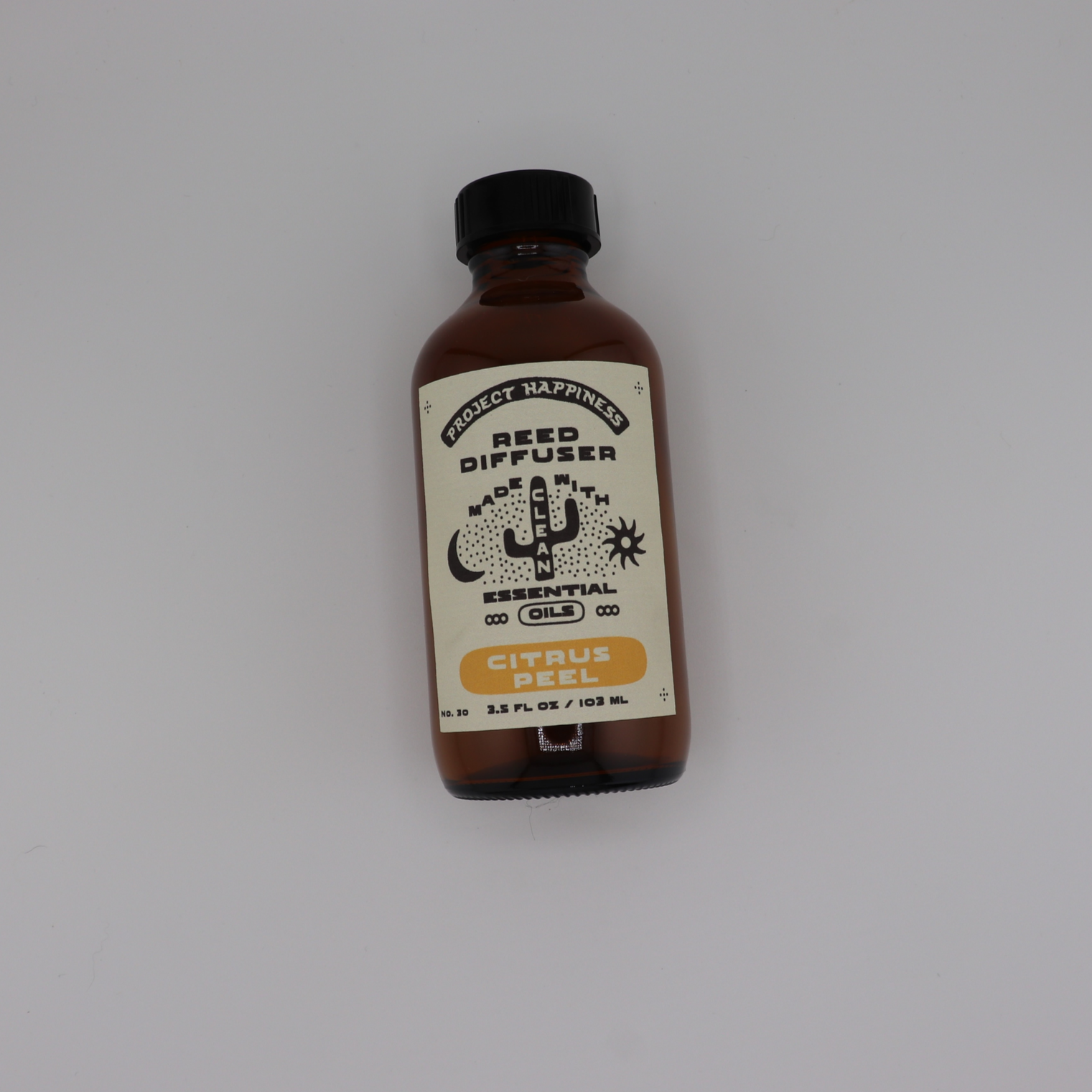 Citrus Peel Reed Diffuser in an amber glass bottle with black reeds, featuring bright notes of orange peel, grapefruit, lemon, and cedar for a fresh, uplifting fragrance. Lasts 3–4 months.