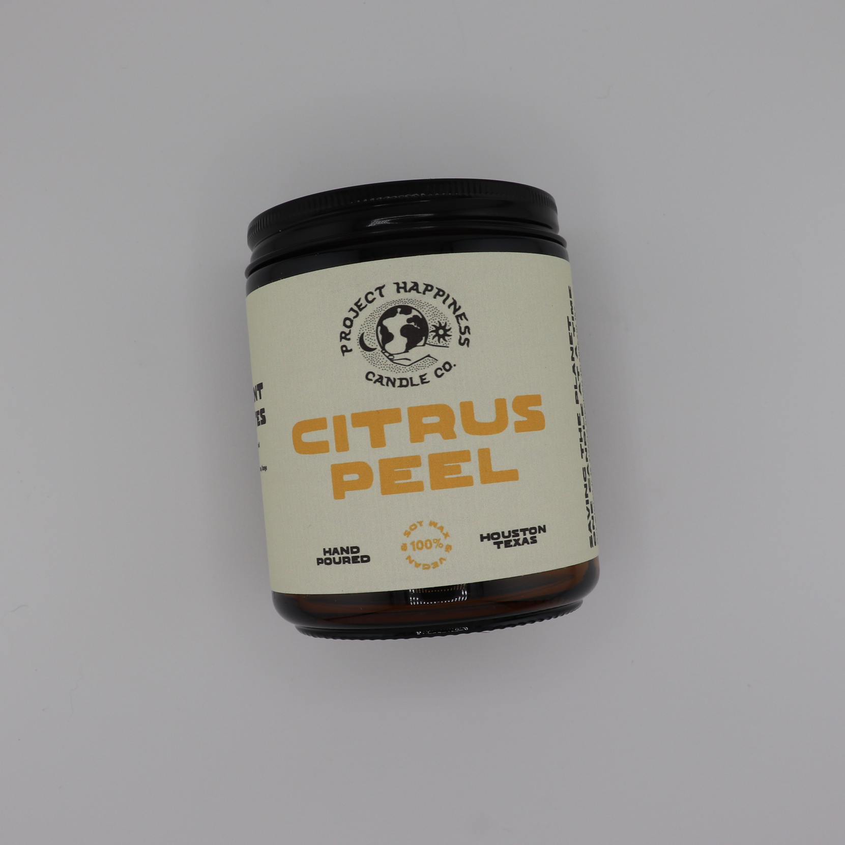 Citrus Peel soy candle in an amber glass jar, featuring cozy fall notes of cinnamon, citrus, apple, berries, amber, pecan, musk, and vetiver. Burns for 45–50 hours.