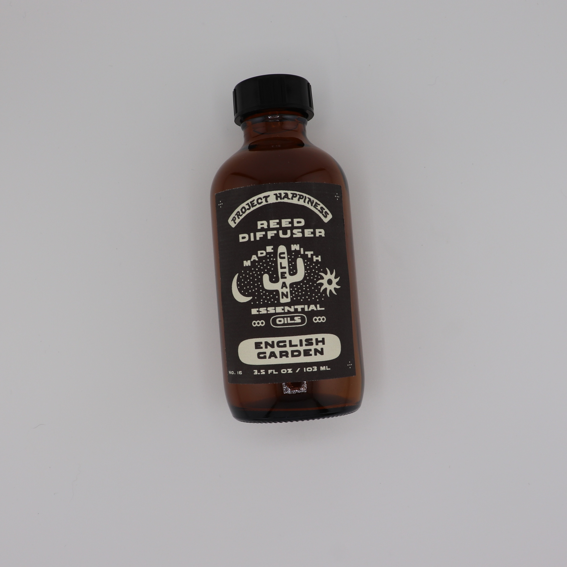 English Garden Reed Diffuser in an amber glass bottle with black reeds, featuring fresh notes of pear, lily of the valley, rose, jasmine, lilac, and vanilla. Lasts 3–4 months.
