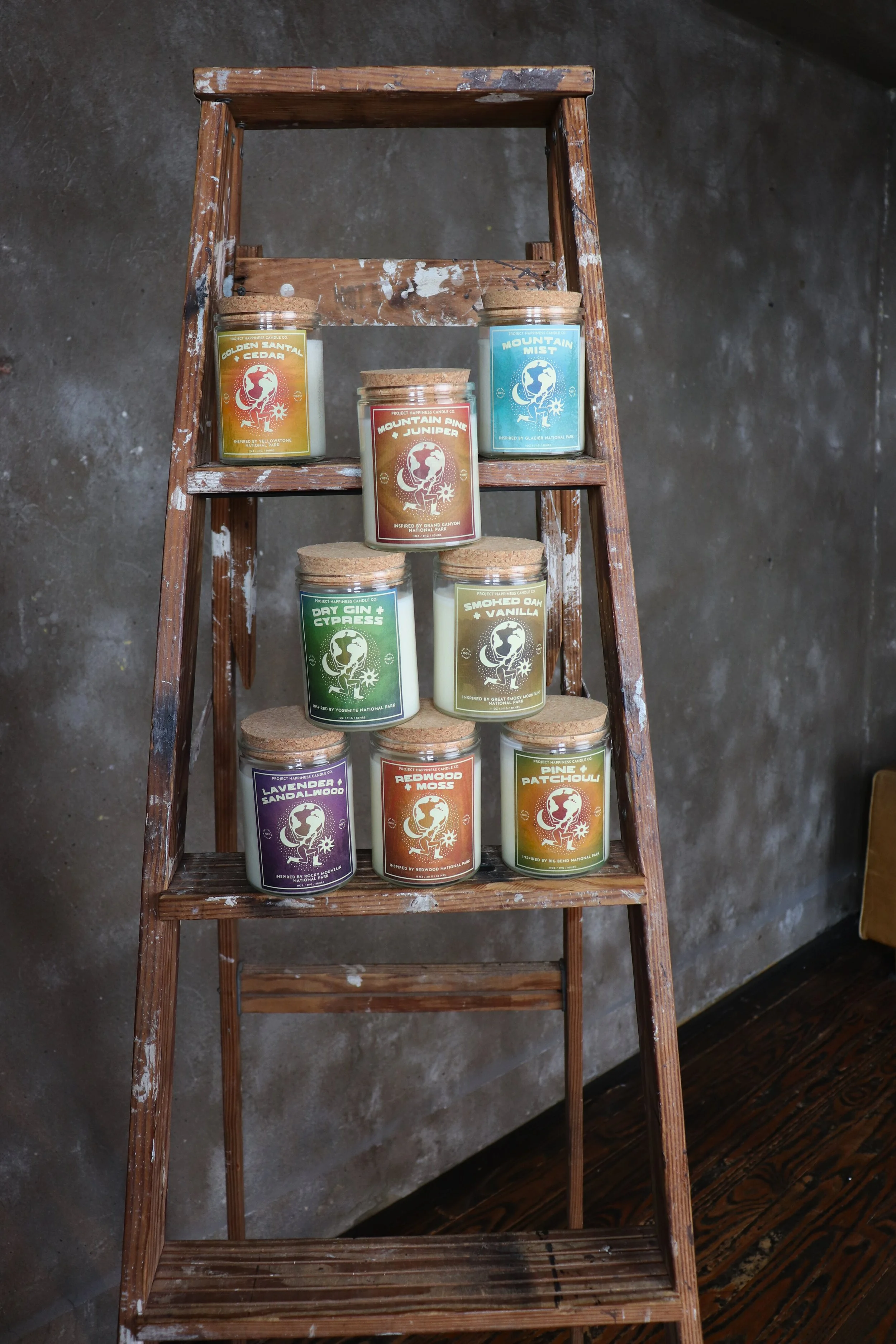 A ladder displaying multiple jars of Golden Santal and Cedar Soy Candle, adding a cozy touch to the setting.
