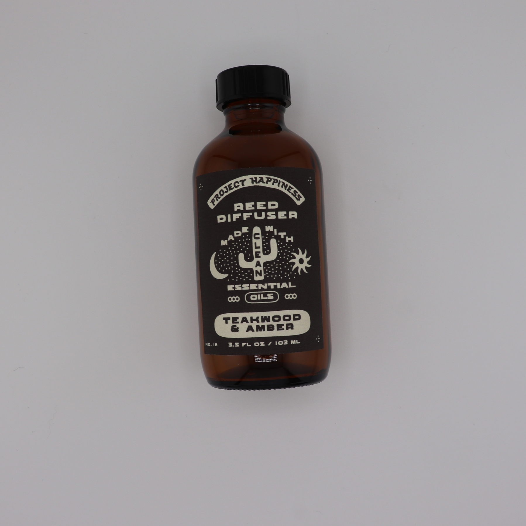 Teakwood & Amber Reed Diffuser in an amber glass bottle with black reeds, featuring warm notes of teakwood, sandalwood, leather, amber, cedar, and dark musk. Lasts 3–4 months.