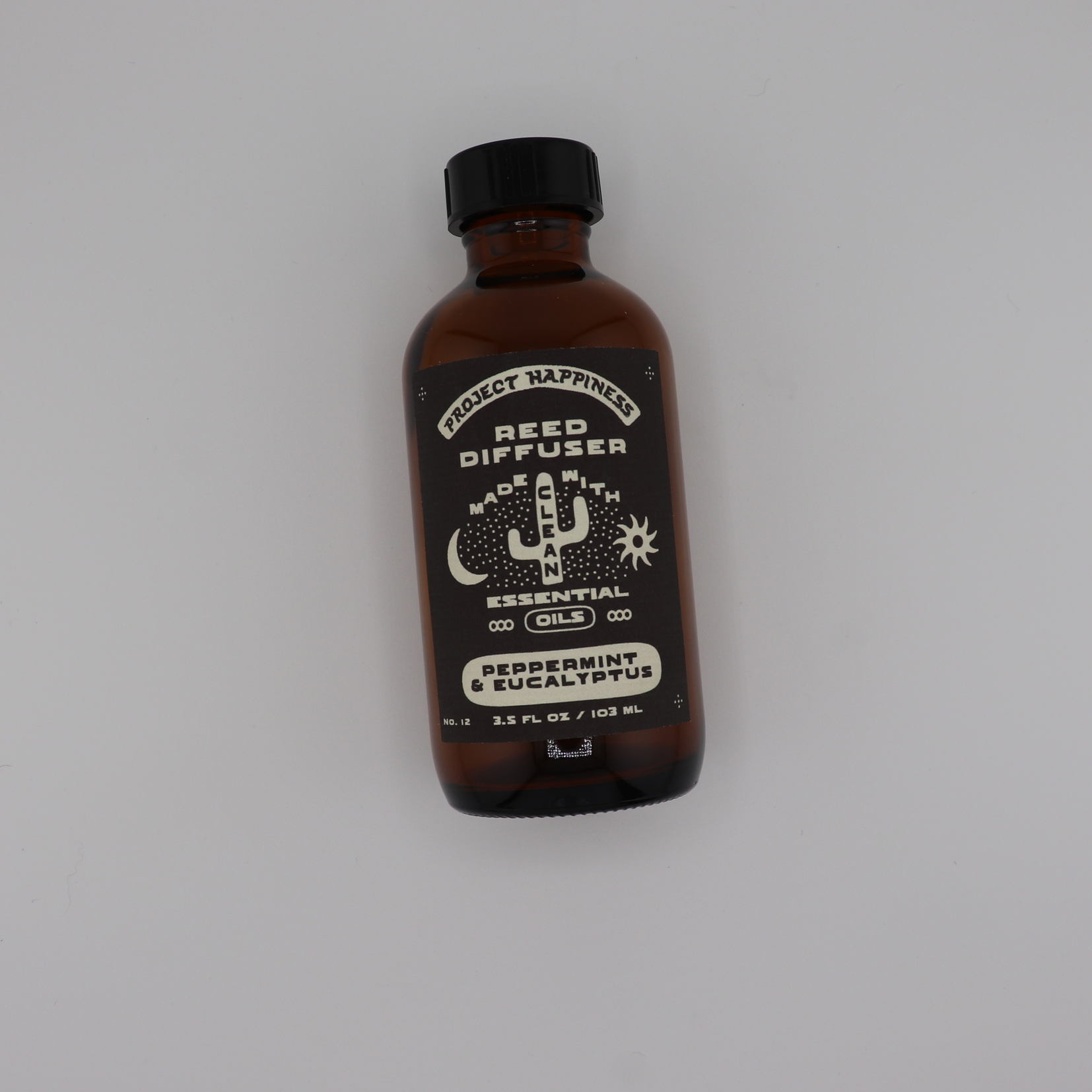 Peppermint & Eucalyptus Reed Diffuser in an amber glass bottle with black reeds, featuring refreshing notes of peppermint, eucalyptus, cedar, vanilla, and patchouli. Lasts 3–4 months.