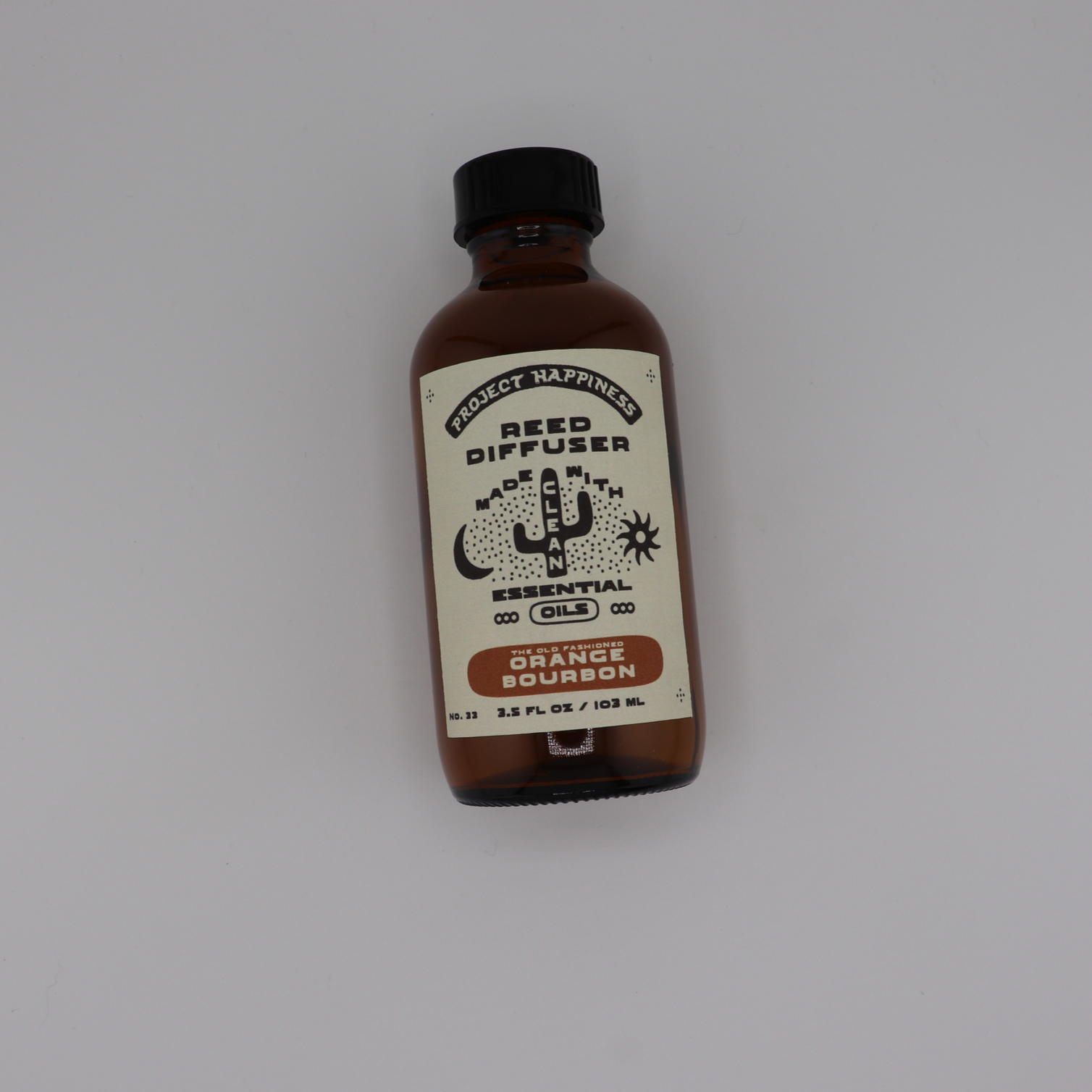 Old Fashioned Orange Bourbon Reed Diffuser in an amber glass bottle with black reeds, featuring bright notes of lemon peel, whiskey, citrus, peach, sugar, and smoke. Lasts 3–4 months.