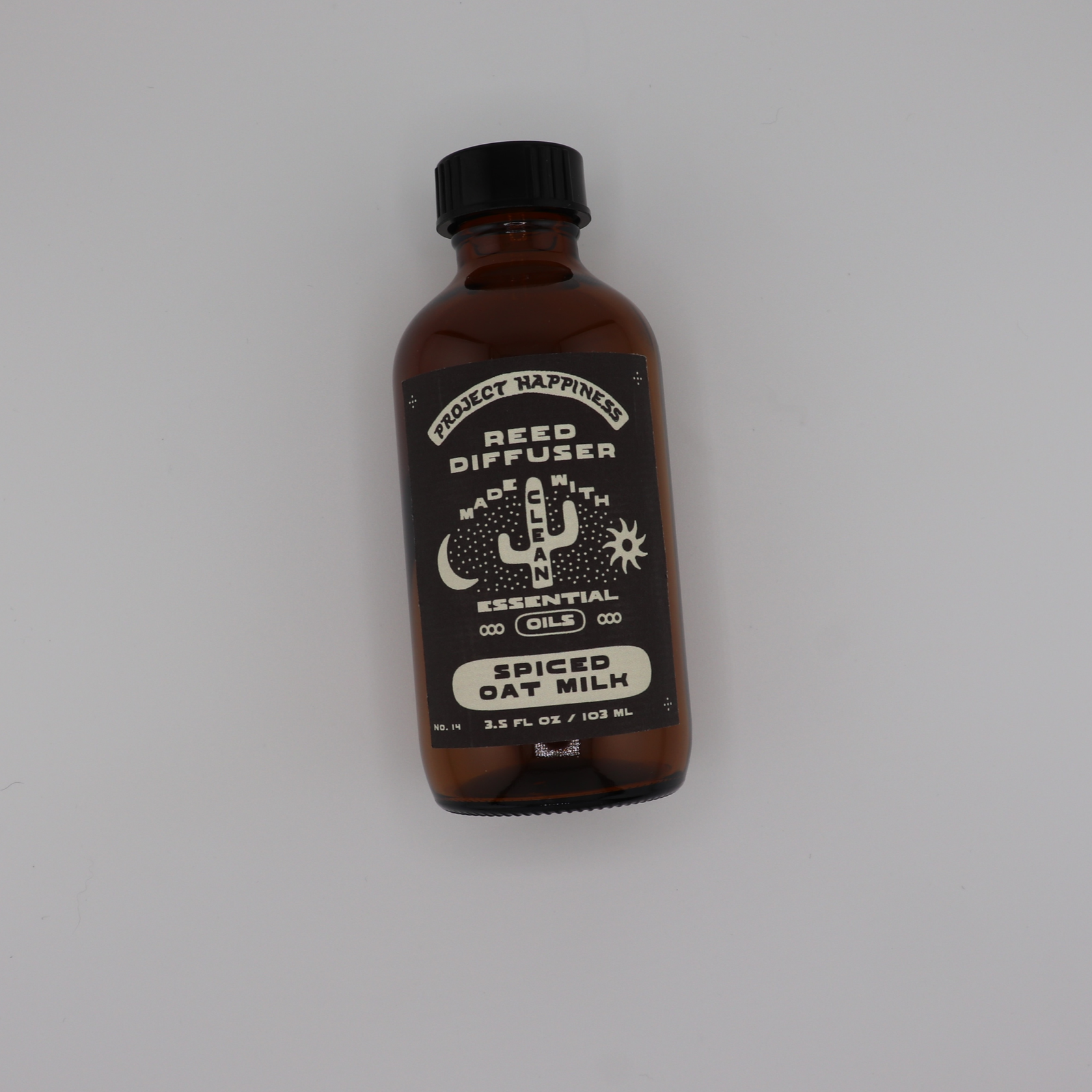 Spiced Oat Milk Reed Diffuser in an amber glass bottle with black reeds, featuring cozy notes of cinnamon, oat, brown sugar, praline, and creamy milk. Lasts 3–4 months.