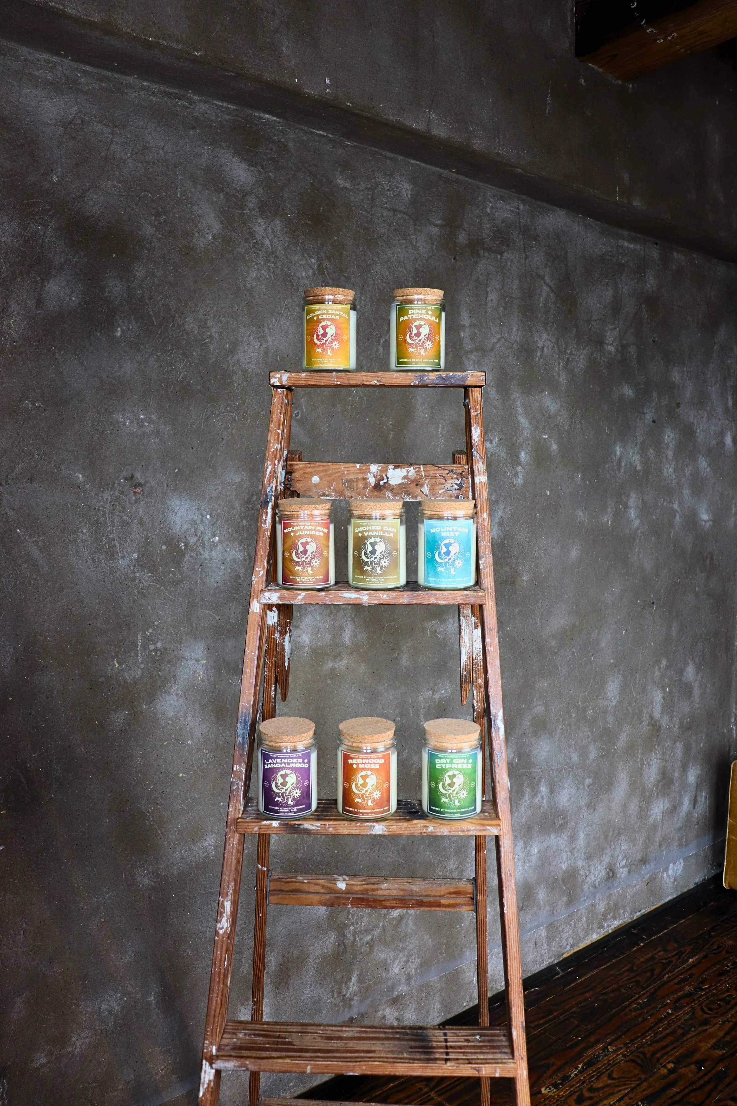 A ladder displaying multiple jars of Golden Santal and Cedar Soy Candle, adding a cozy touch to the setting.