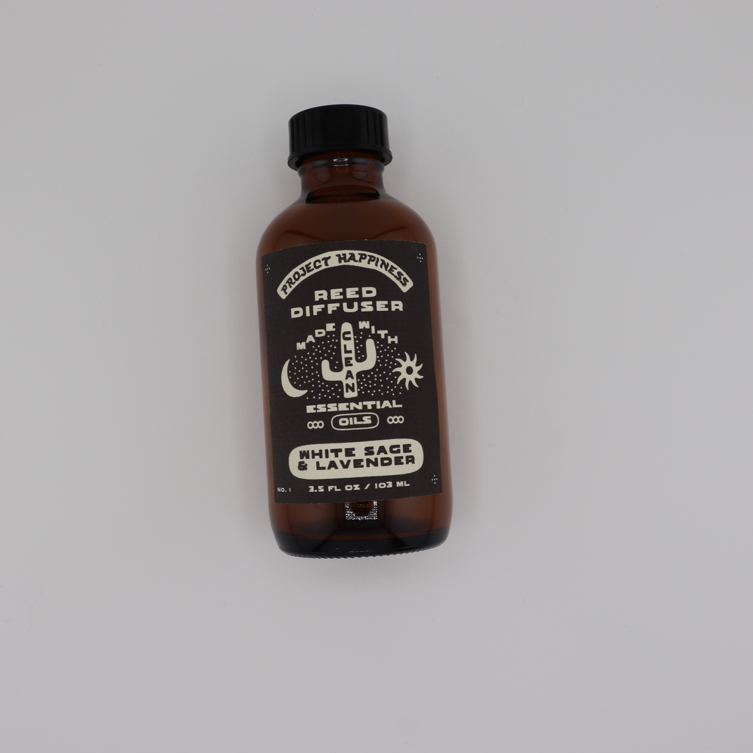 White Sage & Lavender Reed Diffuser in an amber glass bottle with black reeds, featuring soothing notes of lavender, sage, rosemary, chamomile, sandalwood, and cedarwood. Lasts 3–4 months.