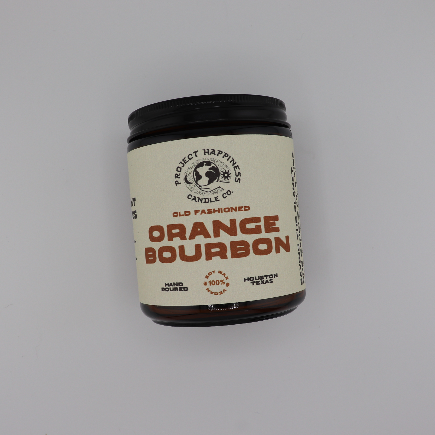 Old Fashioned Orange Bourbon soy candle in an amber glass jar, featuring bright notes of lemon peel, whiskey, citrus, peach, sugar, and a subtle smoky finish. Burns for 45–50 hours.