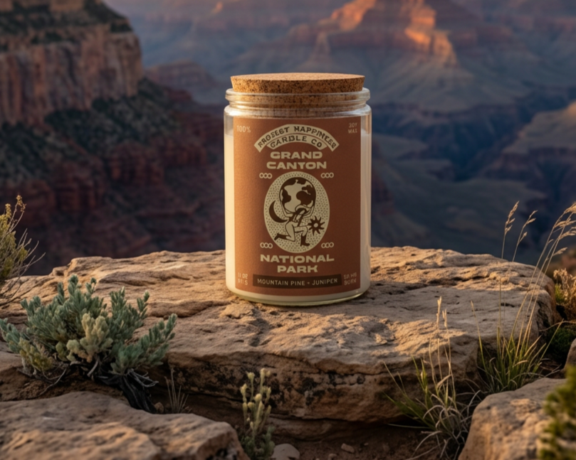 a red label candle sitting on a rock with the Grand Canyon scenery in the background during sunset