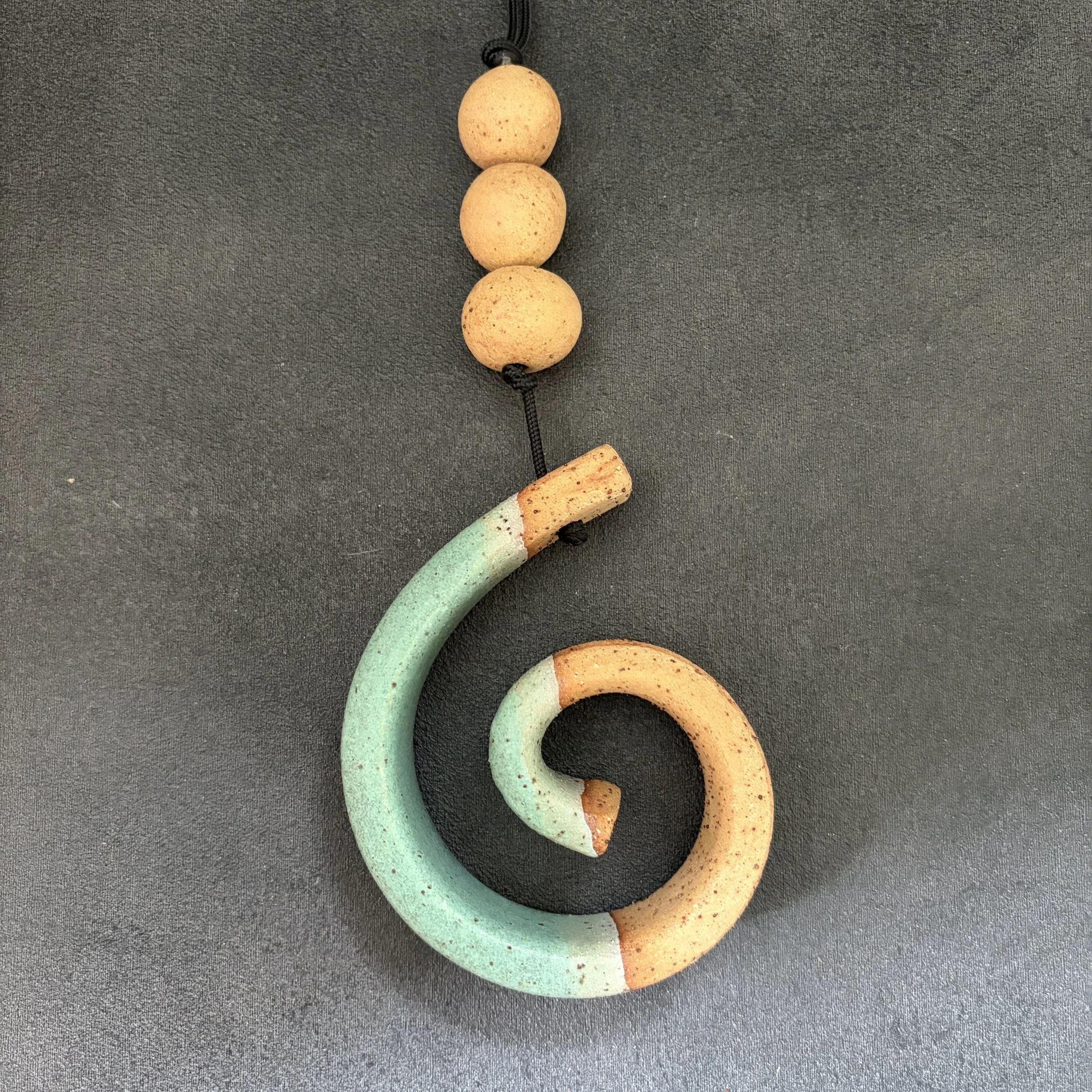 small hanging koru . 826