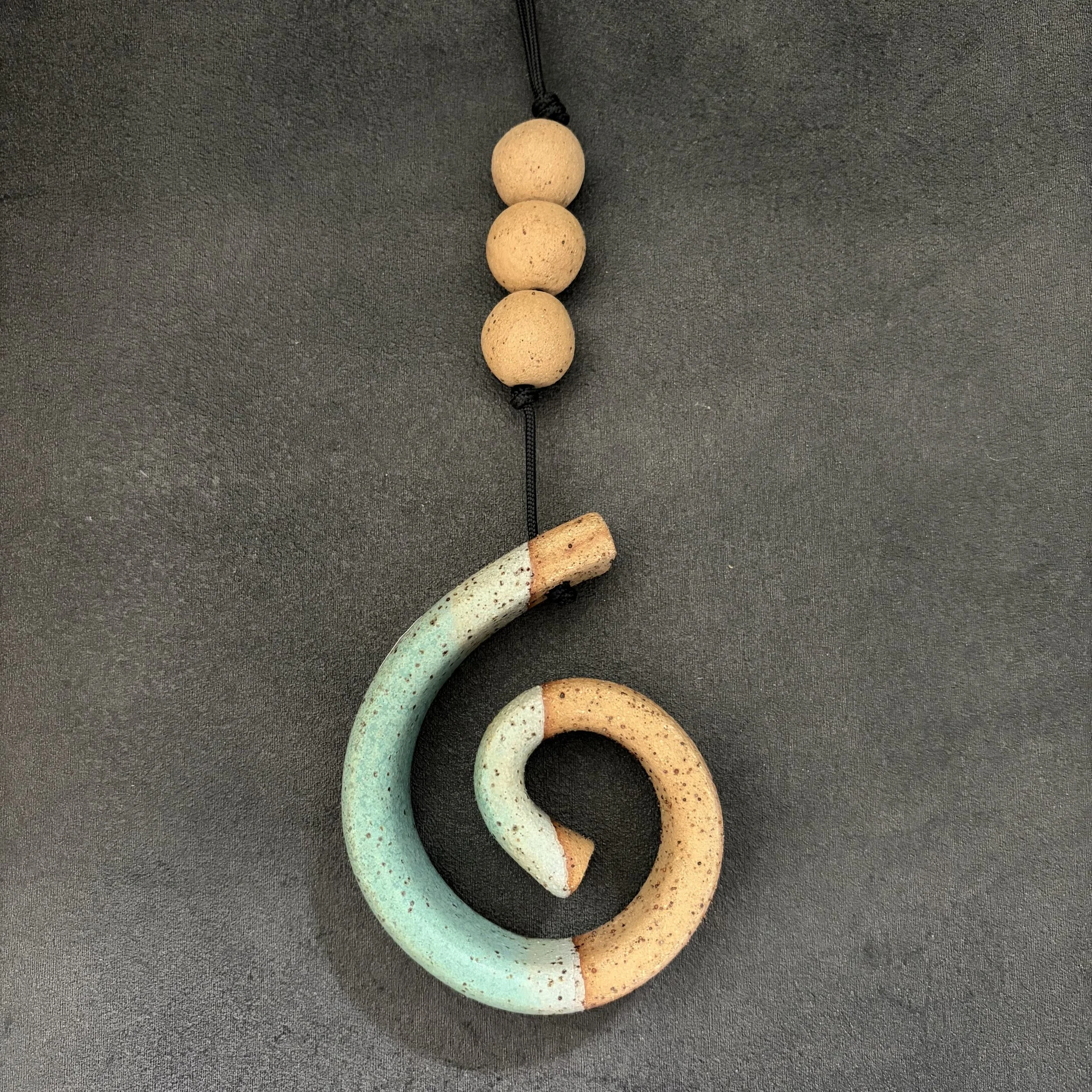 small hanging koru . 816
