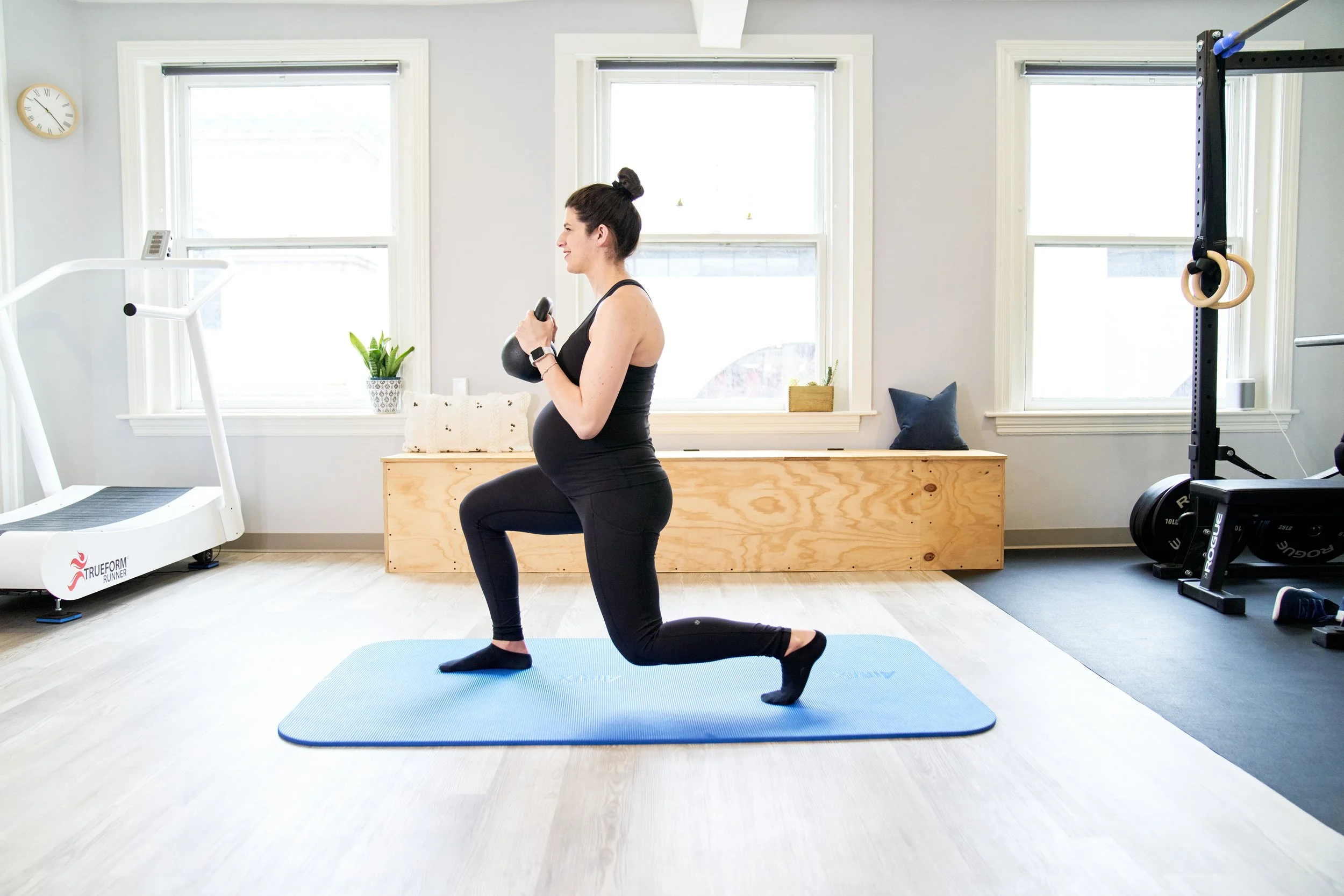 Dr Laura demonstrating kettlebell split squat at Back Bay Health
