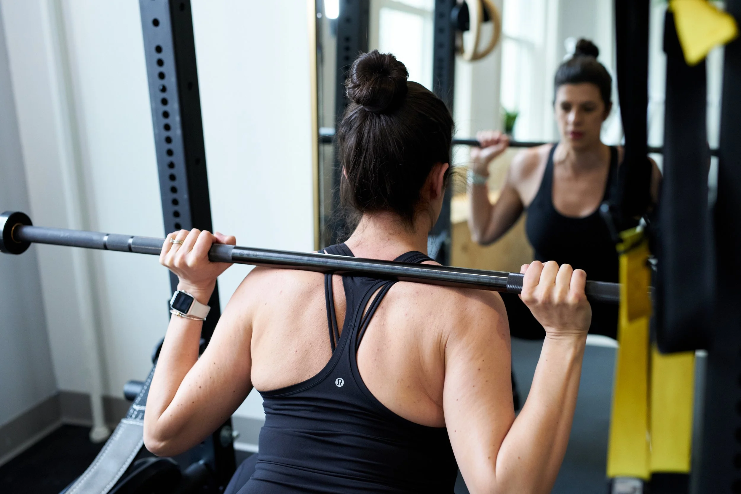 Person back squatting heavy weight - Back Bay Health