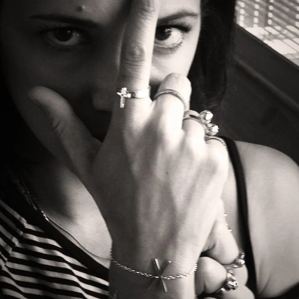 Asia Argento with runic Gebo bracelet and small cross ring