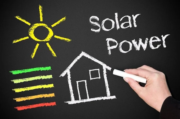 Hand writing on chalkboard with text "Solar Power"