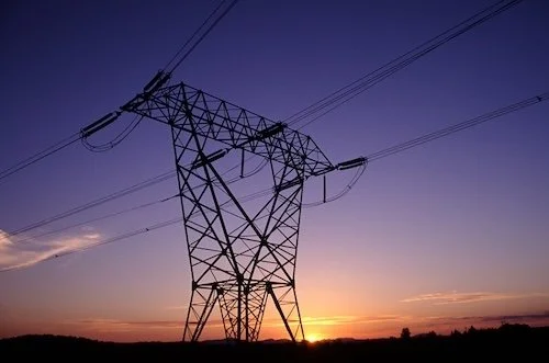 Power lines in front of a purple sky