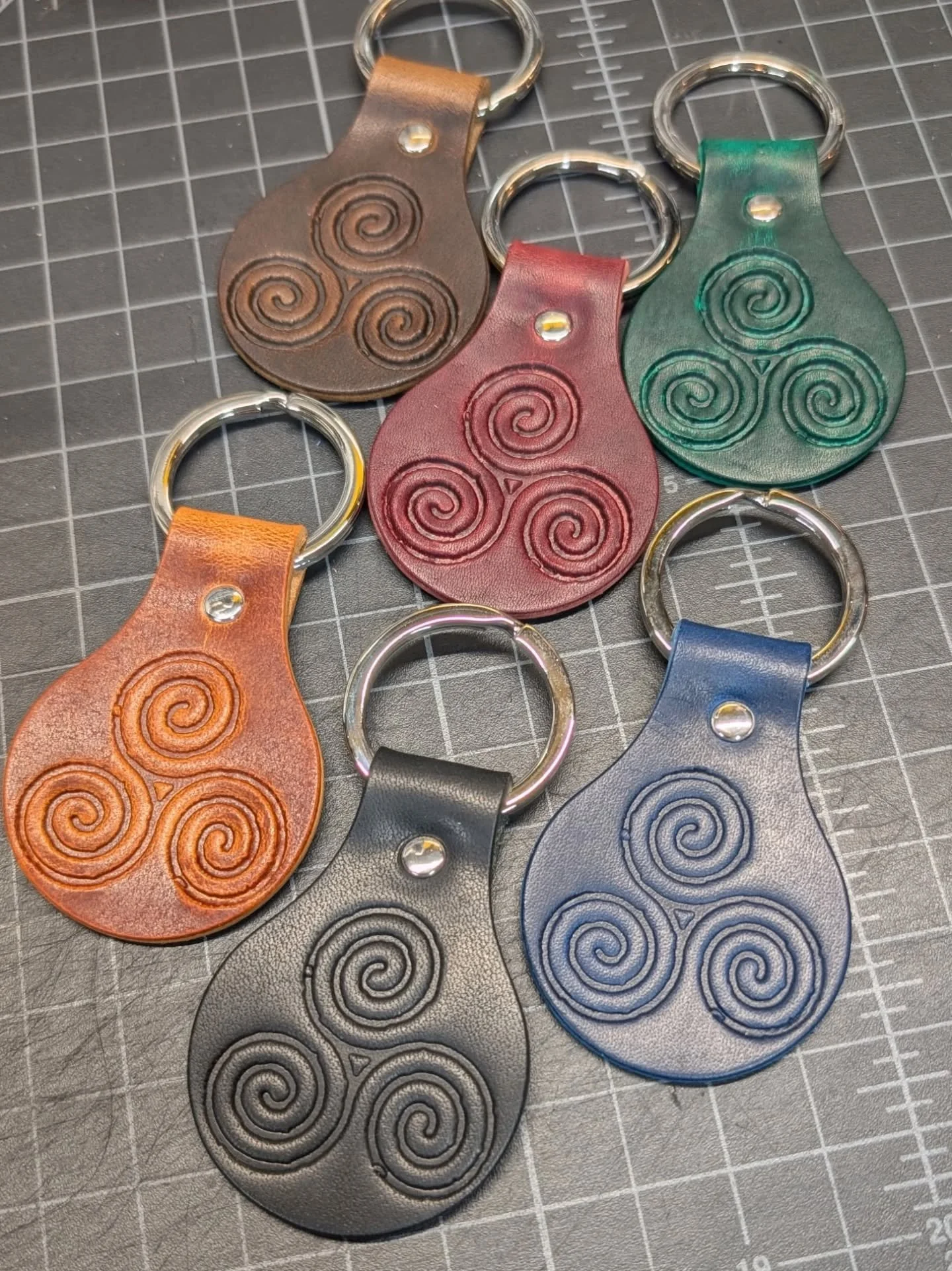 I've wanted the triskelion aspect of my work honored for a very long time but none of the ideas for "merch" felt meaningful until I saw this! High-quality, full-grain vegetable-tanned leather keychains pressed &amp; designed by @caliberleat