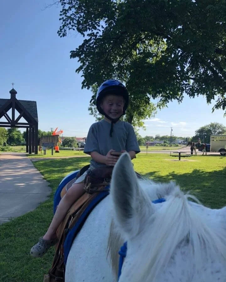SmilingBoyOnHorse.jpg