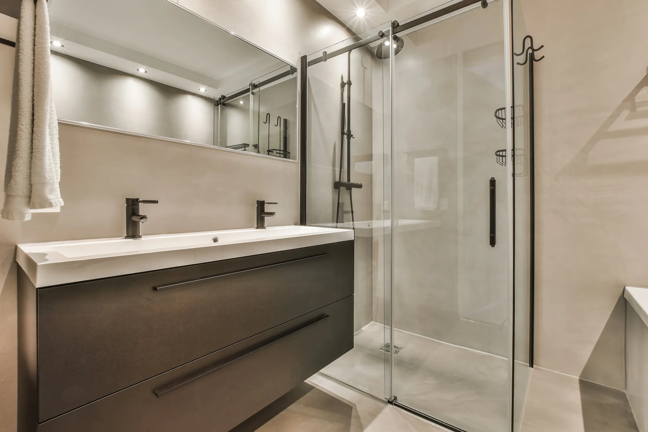 Modern bathroom with dual-sink vanity and glass shower enclosure