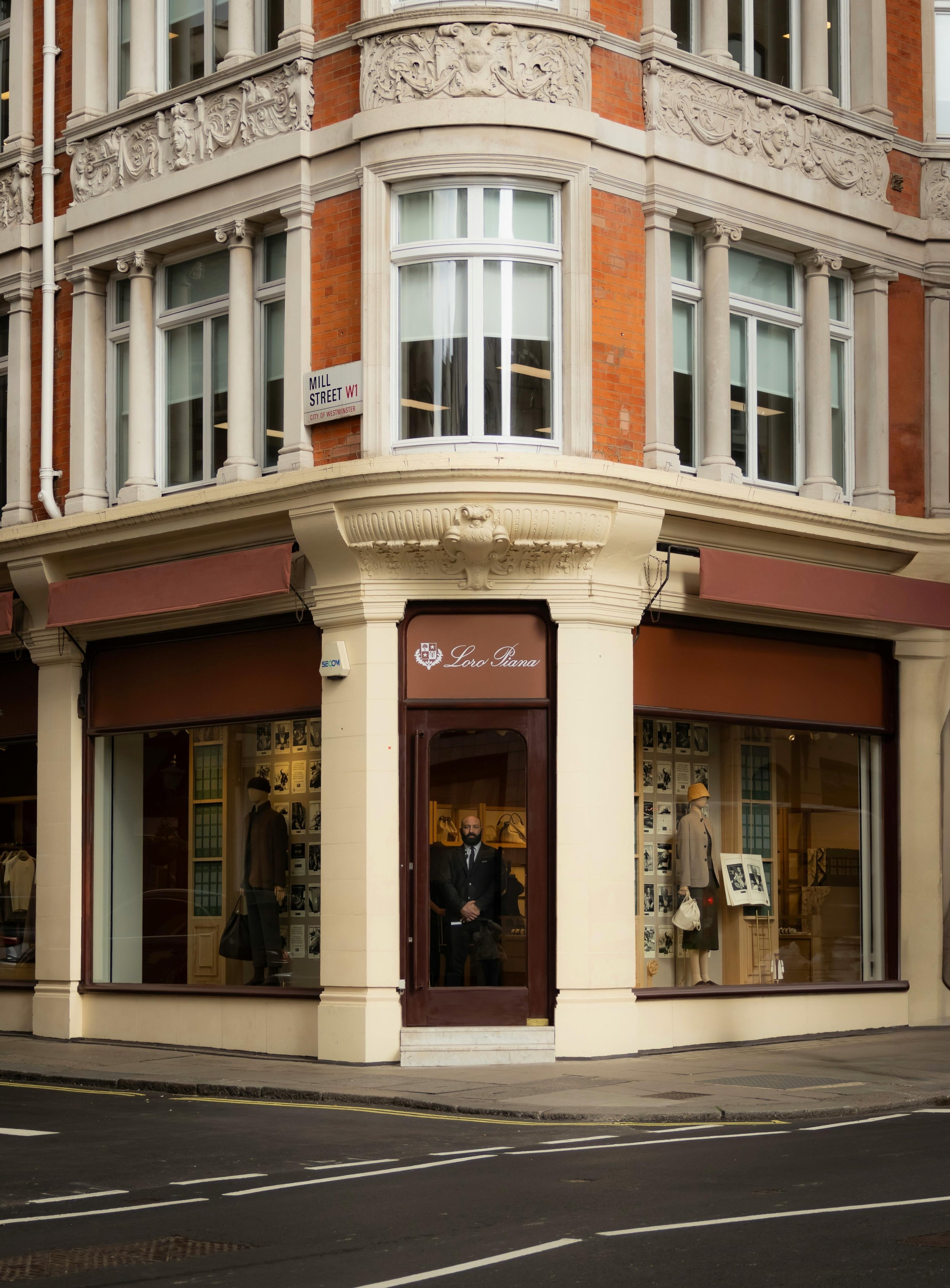 Corner building with a "Loro Piana" storefront, featuring large windows and ornate architectural details, located at the intersection marked as Mill Street W1.