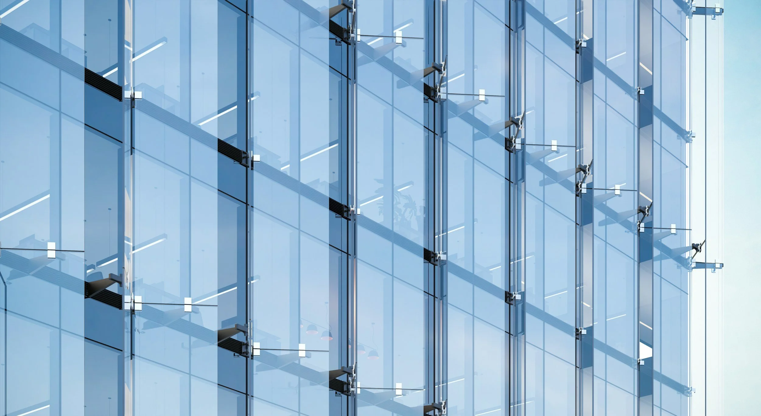 Modern glass building facade with reflective windows and metal fixtures.