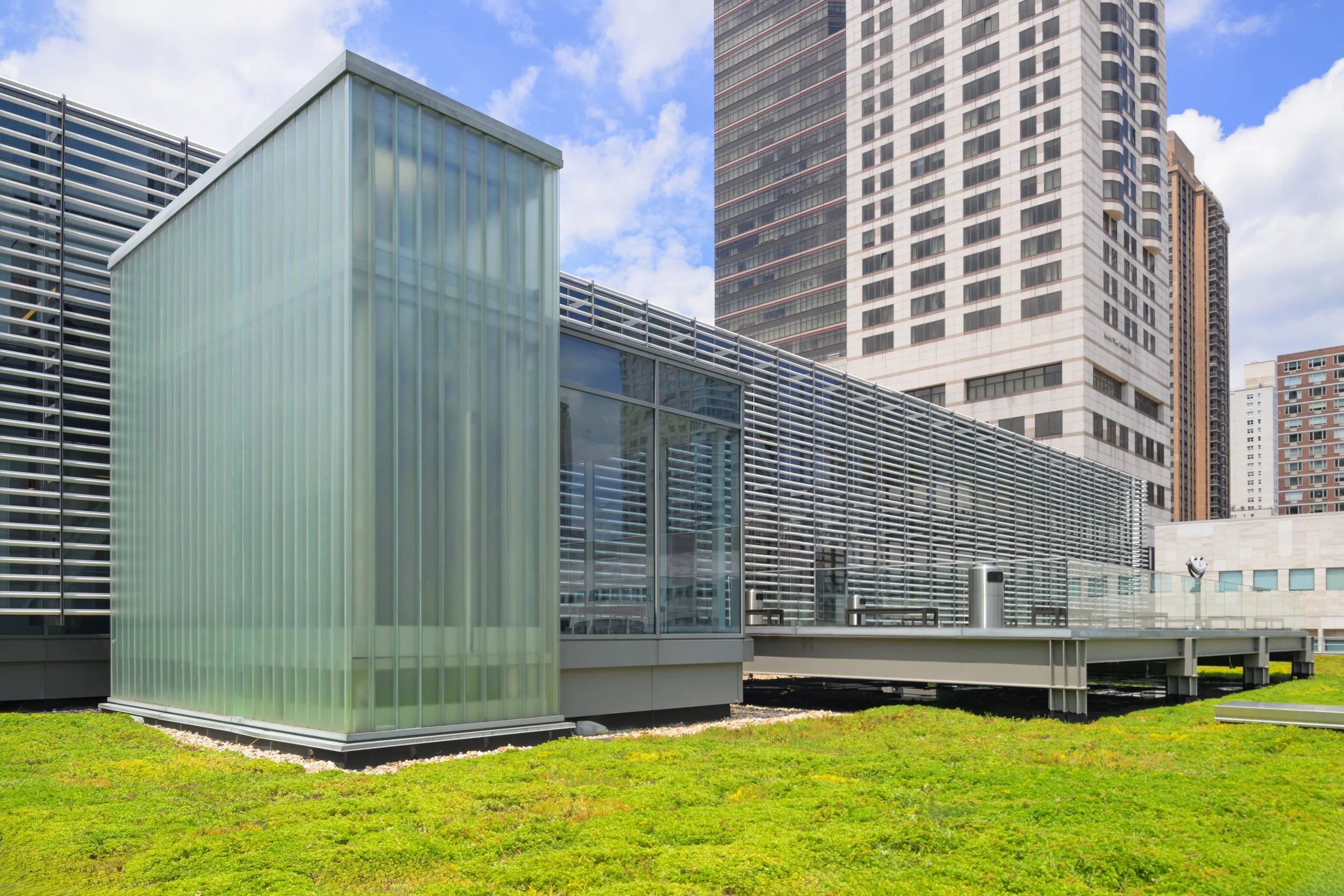 Minimalist white bench in front of frosted glass panels