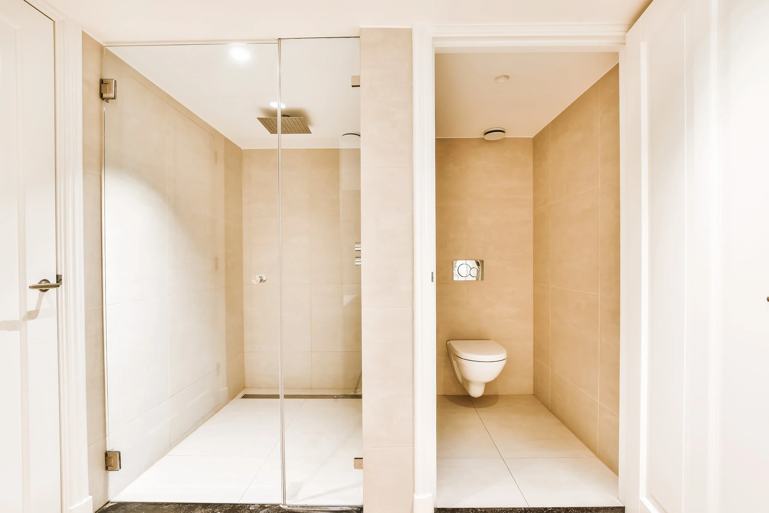 Bathroom with a walk-in shower and separate toilet area.