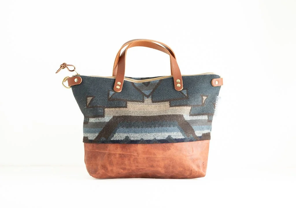 Handmade Blue Shale wool crossbody purse with blue and earthy tones, brown leather bottom, crafted in Portland